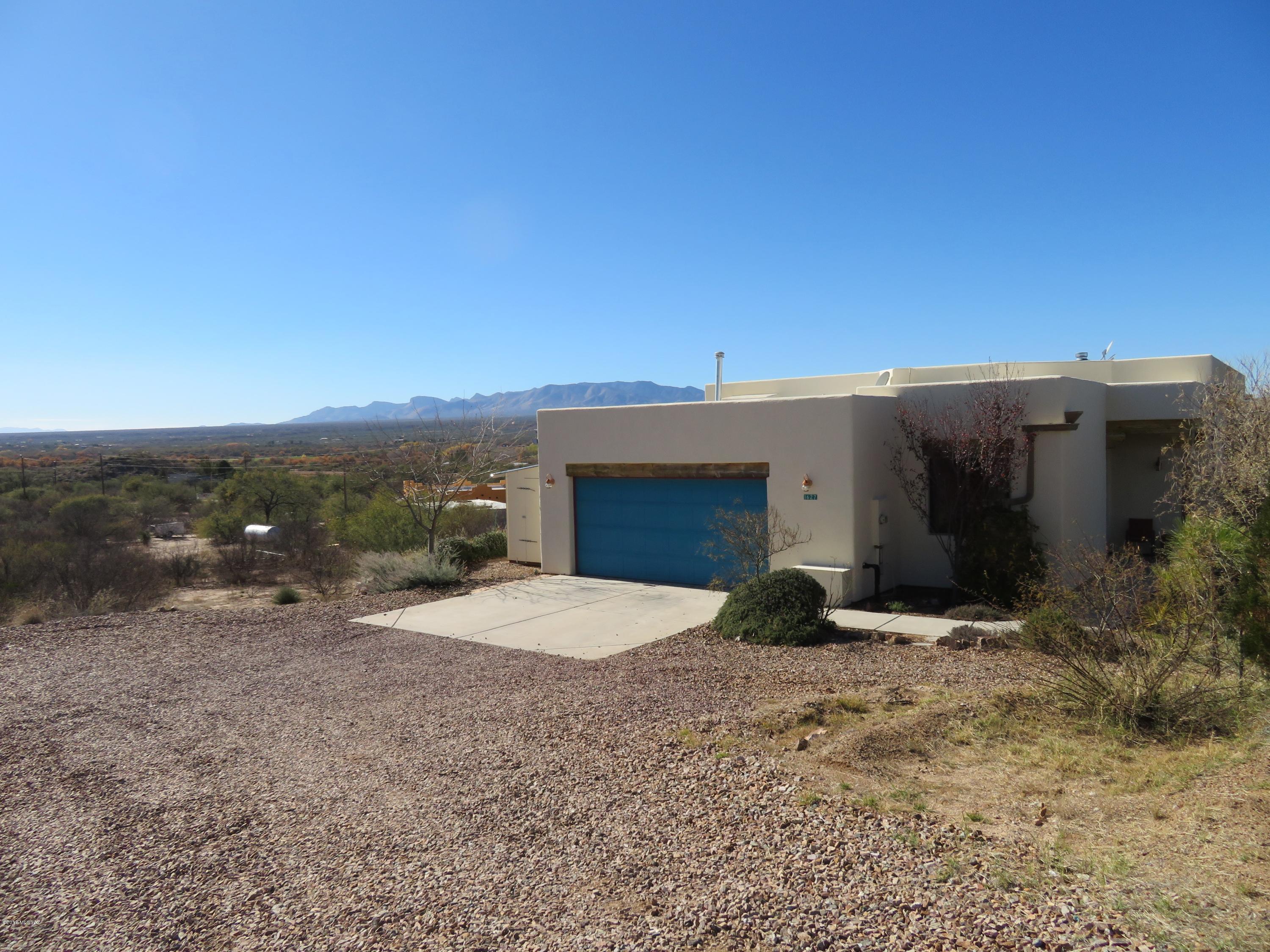 Beautiful Benson Santa Fe Style home with  Fantastic views of the San Pedro Valley!Come take a look that this well maintained home with a spacious Great room with fireplace, oversized windows, tile floors and 10 Ft Ceilings, Split bedroom plan with Large master bedroom with patio door, walk in closet plus additional closet for extra storage, Lovely master bath with dual sinks a step in shower and separate toilet room, 2 bedroom has new carpet and walk in closet, 3rd bedroom is light and bright with oversized south facing window, Hall bath has tub/shower. 2 car garage with extra storage shelves and laundry sink. Private patio with pavers and privacy screen, side yard has  grass and desert plantings watered by  rain water harvesting barrels . Beautiful Terraced Patio for entertaining.
