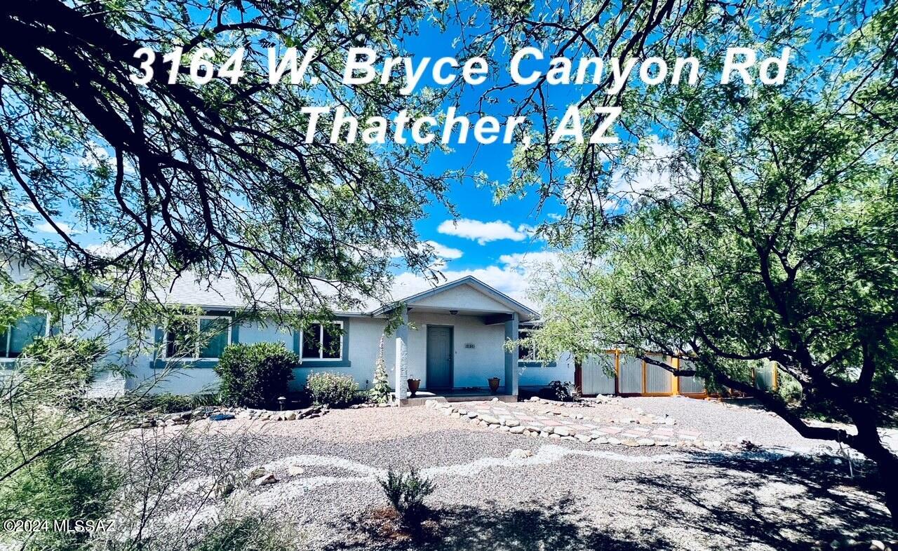 Welcome to your oasis in the desert!  This 3bedroom 2 bath home is encircled with a custom built fence with built in benches and patios.  There are many full grown trees with wandering paths and flowers in bloom.  The automated watering system cares for all of the greenery as well as the garden boxes that are currently growing tomatoes!  There are two large outbuildings.  The one in the yard has a living area, sink  and storage closet.  It can be used as a workshop or could easily be converted into an outdoor guest quarters.  Inside, you will enjoy two large living areas and a generous sized master suite with a soaking tub to relax in.  All appliances are included.  Call for an appointment today!