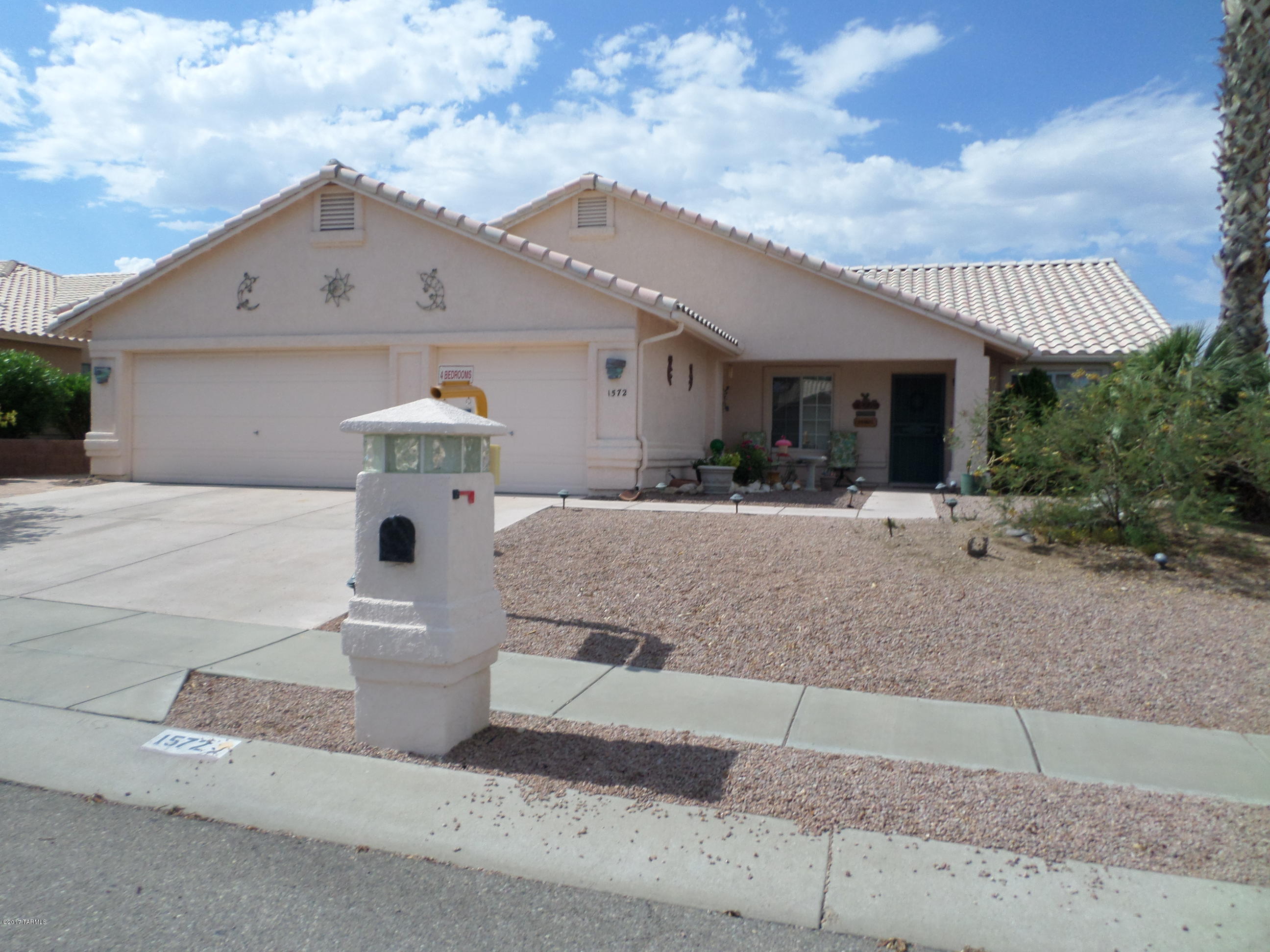 4 bedroom,2 bath home on a large, private lot adjacent to an open space.Nearly all tiled with exception of one bedroom (owner has tile), and living/dining room. Family room is adjacent to eat-in kitchen. Beyond is a large heat/cool AZ room w/ concrete stained floor. Enter the master suite through double doors, enjoy the walk-in closet, & large bath with double sink vanity & large linen closet. 4th bedroom serving as an office with double doors to entry,Back yard has a hottub, built-in bar-b-que, water feature. There are 2 citrus trees, some roses, shade trees, and flagstone walks & patios. A nice side yard affords a hidden clothesline. The 2 ft. extended garage is great for growing families or use it for storage or a workshop, great possibilities.