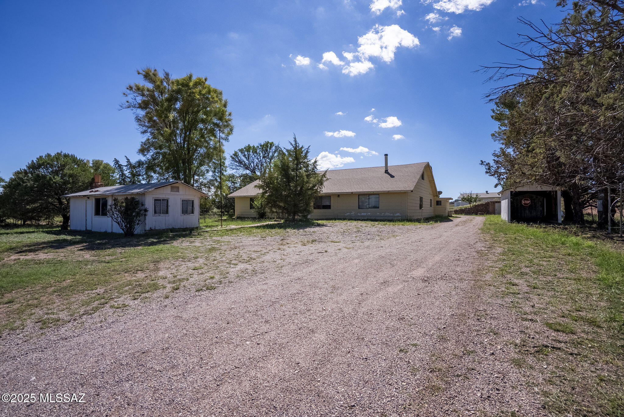 Amazing opportunity to own this property in the heart of Sonoita/Elgin wine-country, situated on over 8 acres, offering TONS of potential. 3,470 Sq Ft main house, 240 Sq Ft guest house (perfect for long-term or short-term rental with immediate income) , wine/root cellar, 1,300 Sq Ft unfinished 2nd floor/loft in main house (not included in listing square footage), large workshop, storage/sheds, horse corral, abundant with trees (willows, pines, pomegranate & cherry). Just minutes from local vineyards, dining, and outdoor recreation, this home is ideal for multi-generational living, a retreat, or a potential B&B. Experience the charm and tranquility of rural Arizona living, with all the space you need to make it your own. A rare find in a highly desirable location.