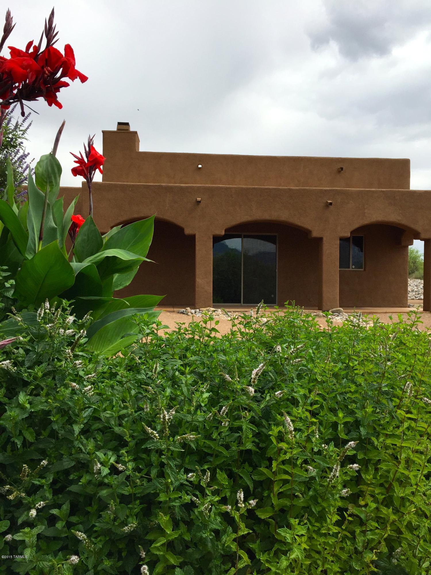 Located near Miraval wonderful custom home on acre lot offering plenty of room for toys - RV, trailer, horse.Two oversized guest rooms share beautiful full bath, large laundry room and expanded two car garage. Kitchen with breakfast bar, newer stainless steel appliances, granite counters and backsplash, pantry and cherry wood cabinets. Slate fireplace, Hunter Douglas ceiling fans, stained concrete flooring.See full features list under documents. Water bill $25.00 per month and no HOA!