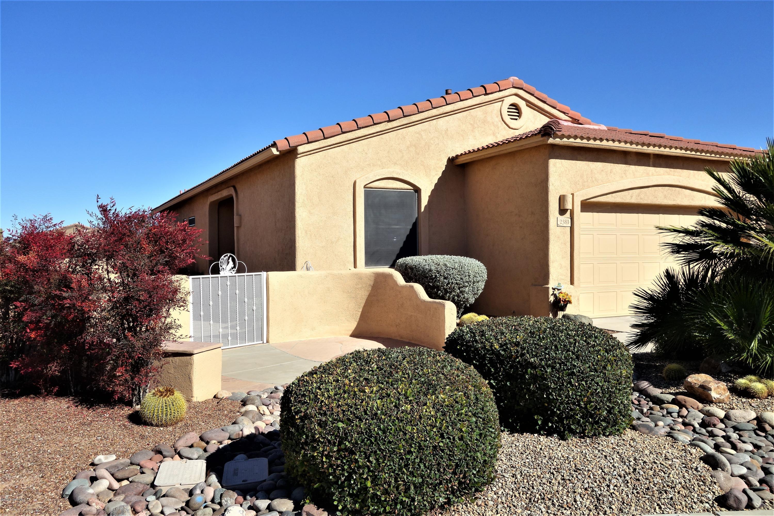 This stunning modified Palmer offers a lovely view of the Santa Rita Mountains. Enjoy outdoor living in one of three uncovered patios complete with built in backyard BBQ. Or enjoy a more private outdoor experience from the Lattice porch or lovely AZ room. The interior is just as lovely with custom, decorative tile floors throughout. The kitchen features granite counter tops, upgraded wood cabinetry and top of the line appliances. The guest bath features a customer tile enclosure and new tub, while the master features a fully tiled shower with bench. Both were upgraded with elevated commodes and elevated, cultured granite counter tops. New Low E windows with wood blind coverings were installed throughout, and A Trane Clean Effects heating and cooling sytem was added in 2013