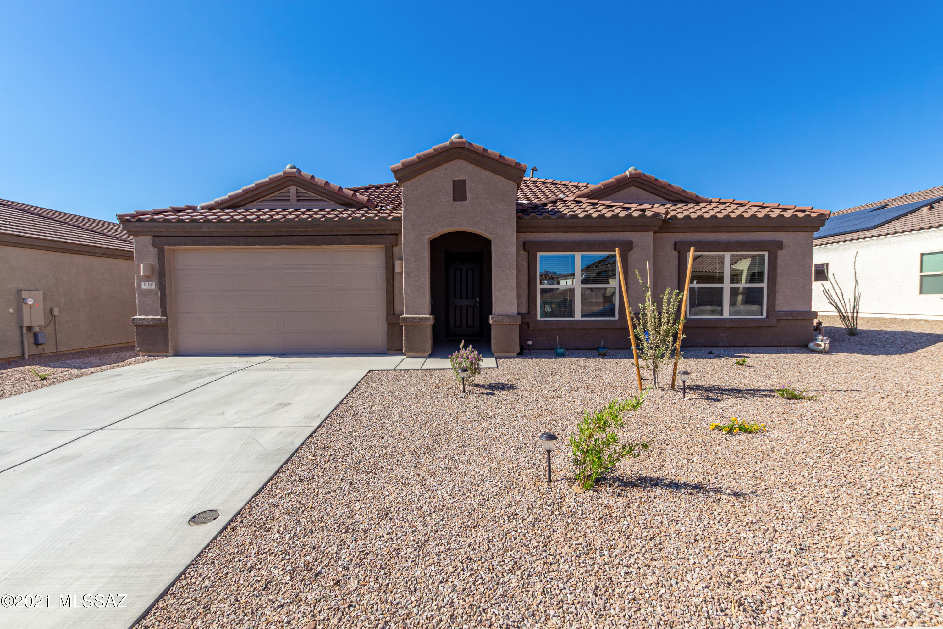 Don't miss the opportunity to own this wonderful 4 bedroom, 3 bath home.  High ceilings, wood-look tile floors,  trending palette, upgraded ceiling fans, & open floor plan. Formal dining area.  Stunning chef's kitchen features plenty of handsome cabinets with crown moulding, pantry, granite countertops, SS appliances, and island with breakfast bar. Flexible den ideal for reading. Plush carpet in all bedrooms, ample closets, & pristine baths. Master retreat boasts   ample space, ensuite with dual sinks, & a large walk-in closet. Enjoy the covered patio and  endless blue skies. RV gate. Take a tour today!