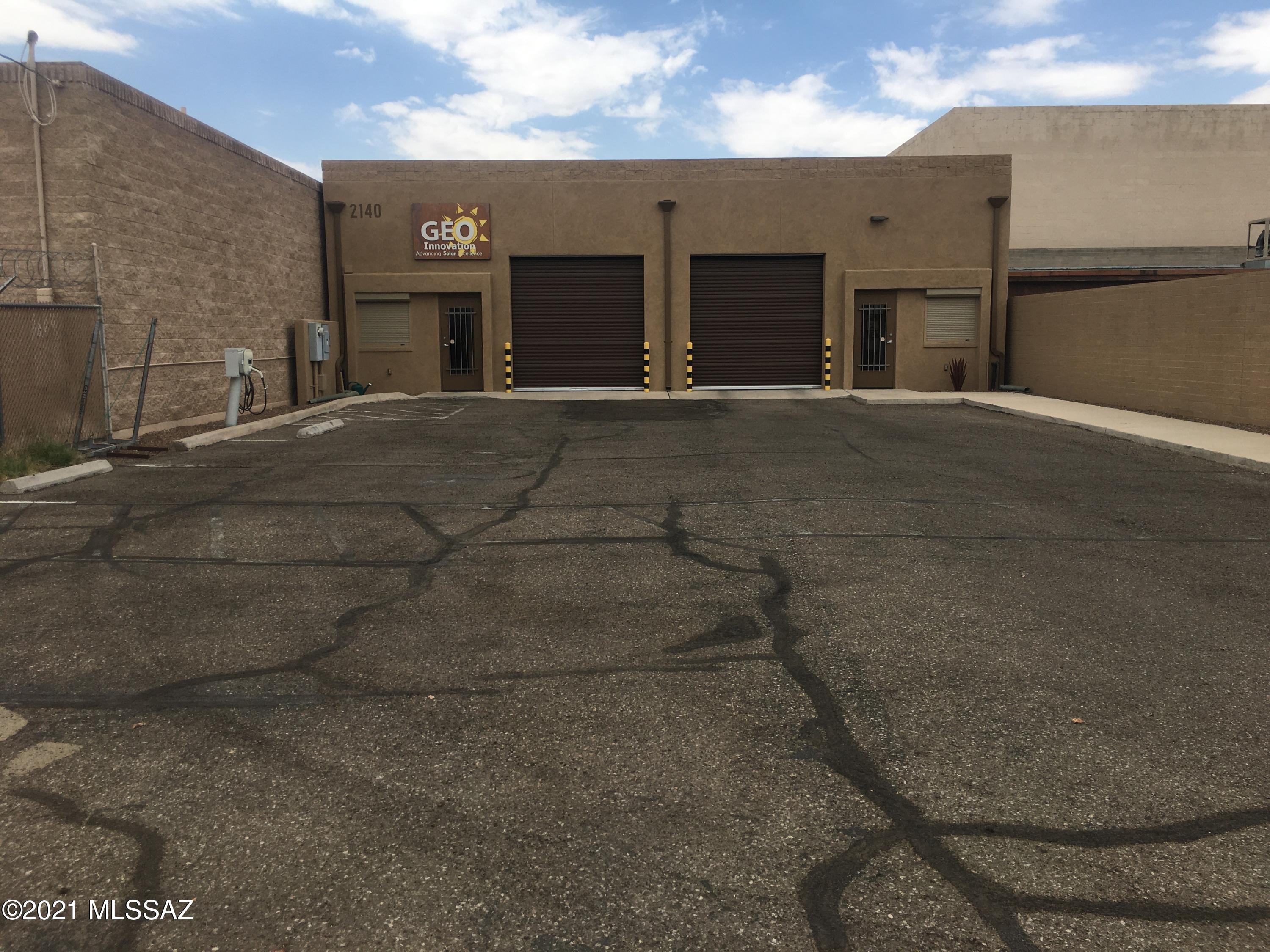 Hard to find smaller industrial zoned property. Split faced block construction in 2006, offering ample parking or use as a secure equipment yard.  Motorized gate entrance, 2 10' insulated roll up doors. East and west side of the floor plan are mirrors of each other and could be easily split into a 2 unit property.  Occupy one side, lease the other. Minutes from downtown, University of Arizona, and I-10.