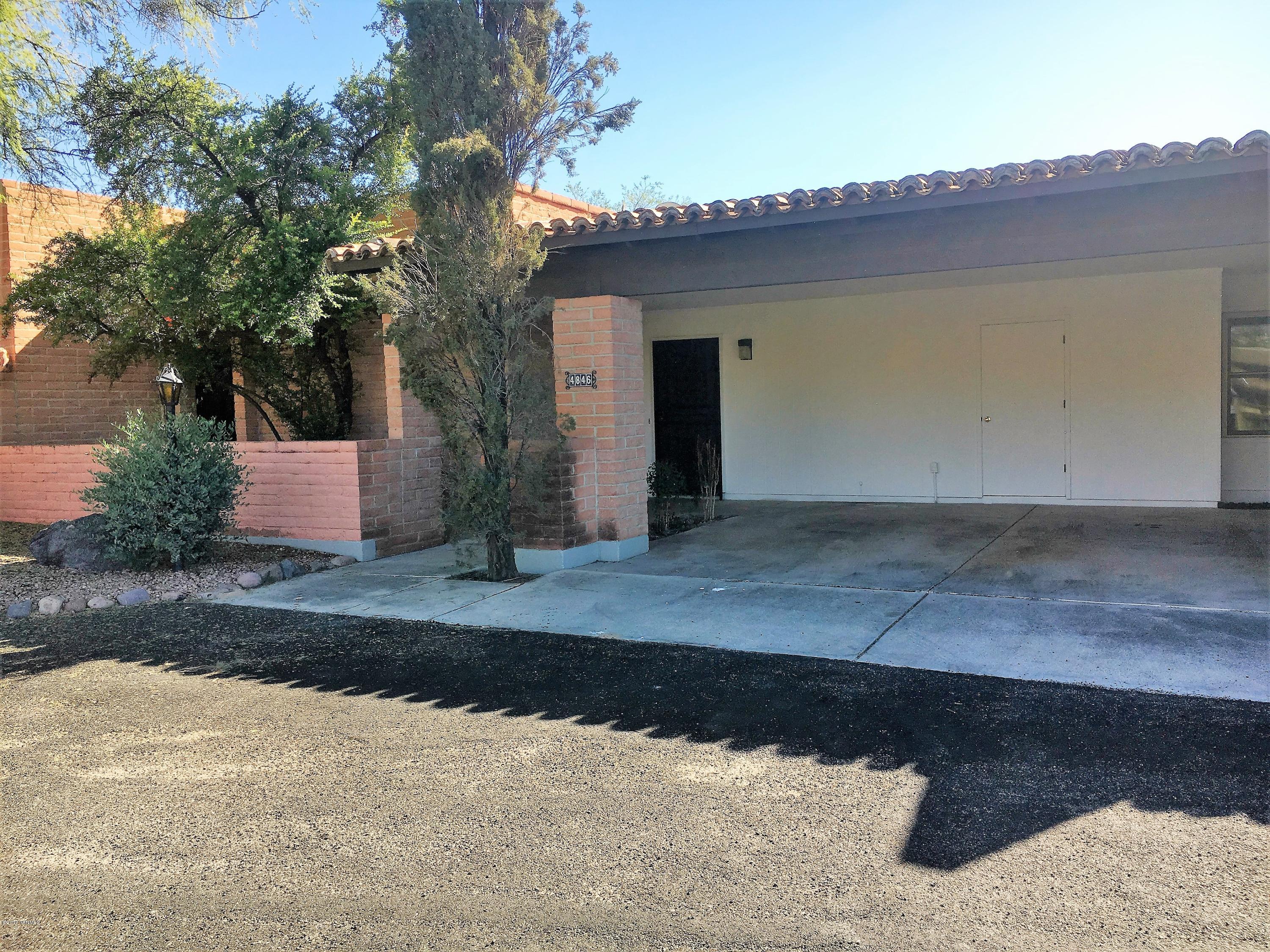 Convenient location, courtyard VIEWS of the Catalinas to die for, walkable to dining and shopping. This block constructed town home features 3 bedrooms, (one with its own front and screen door) 2 bathrooms, new tile everywhere but bedrooms, fresh paint, loads of living space and a full length, private back patio for relaxing while seeing peeks of city lights at night. Great place to try your hand at container gardening! Kitchen has a brand new electric stainless range and refrigerator. You will not believe the amount of cabinet space! Eat in kitchen as well as a pass through bar to the living room which features a beehive fireplace. The two car carport also has a locking storage closet for your typical ''garage'' stuff. Skylights provide natural light.