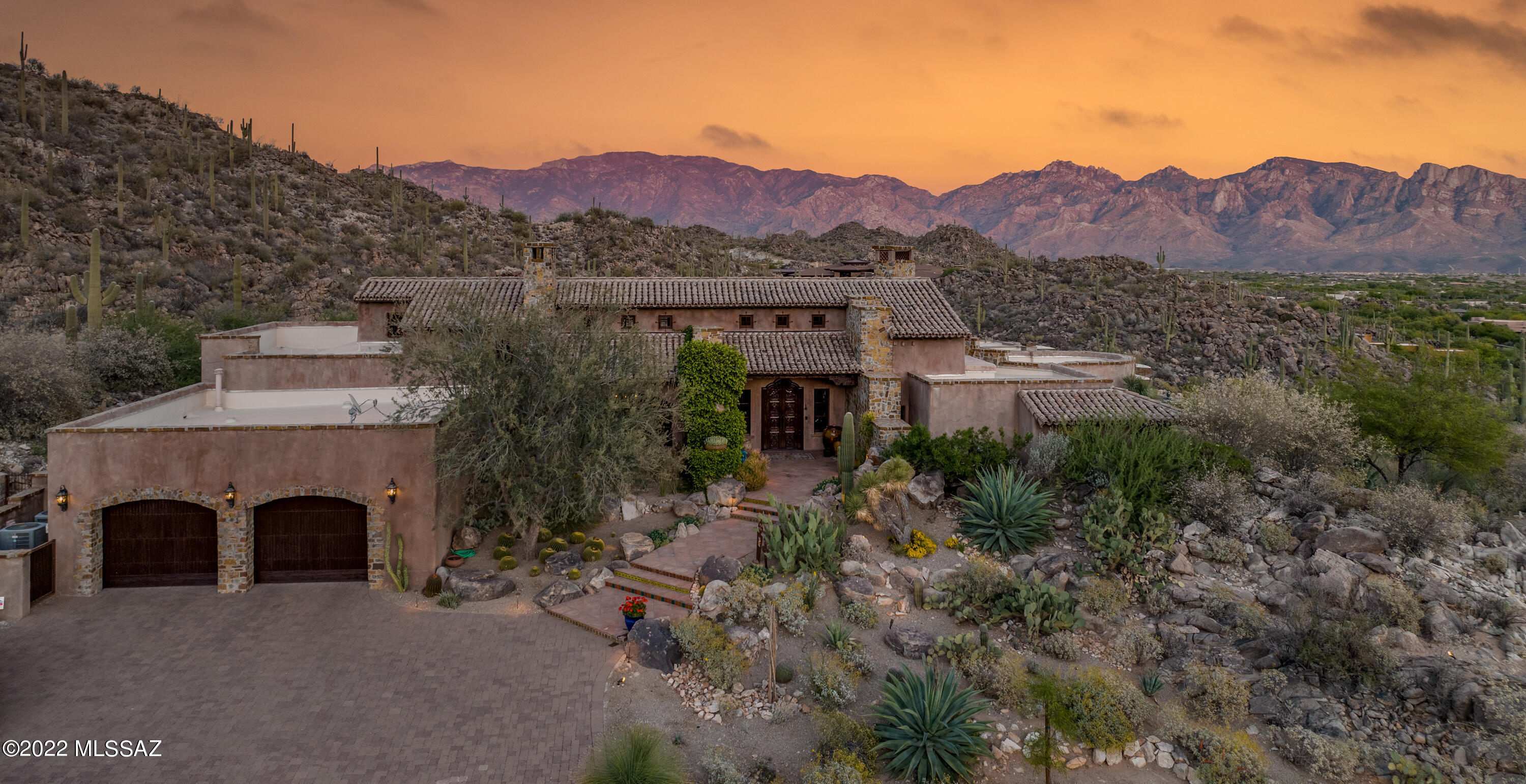 *OPEN HOUSE * SUN 5/7 * 2:00-5:00PM*  
Casa Tranquillo awaits as you make this private hilltop sanctuary the next place to call home.  The allure begins as you drive up the illuminated private drive welcomed by the creative desert landscape and continues to amaze the moment you walk in the front doors. The renowned Scottsdale Alan Tafoya has truly created a one of a kind custom home with influences from San Miguel de Allende, Mexico Southwest blended with mission style elements.  Madison Courteriors took two years to complete this unique home with the finest materials and workmanship.  Everything is designed to feel authentically aged from the reclaimed wood floors to large distressed ceiling beams, custom colored malibu tiles on the main fireplace, handcrafted saltillo tiled floors, imported antique doors throughout, the list goes on. It exudes warmth with the soft ivory colored Venetian Plastered walls and views looking out to the desert landscape in every room. When you step into the gallery sized kitchen you can't help but notice the large mesquite diamond pattern island, antique doors to your walk in pantry, red Viking range with copper hood all picture perfect for fun experiences with friends. Sit in the comfy corner banquette with your morning cup of coffee enjoying the serene desert and mountains beyond. Walk down the unique cross beamed hallway to your master suite with cozy kiva fireplace, full rock wall and views of honeysuckle and mesquite tree shading your jacuzzi awaiting you. The master bath has a distinct spa feel with calming natural stone tile, free standing tub, large shower, two large walk in closets, and outdoor shower nearby.
Your guests will love the cozy guest rooms with views, in suite baths and built in twin size platform bed for reading a book or extra little guests.
For the best view in Stone Canyon just step outside to view the large covered latilla ceiling patio with tree size pillars and rock fireplace to keep you warm for those cooler outdoor dinners enjoying the pink moment of the mountains nearby. One unique feature of this home is the infinity edge pool built into the natural rock outcropping and listening to the two waterfalls.
At night sit on the lower patio roasting marshmallows around a fire pit and watch the city lights twinkling beyond.
You can find this one of a kind two acre estate in the picturesque Tortilla Mountain Stone Canyon Golf community.
This luxurious gated community stretches over 1400 acres of breathtaking desert accompanied by an opulent health and fitness facility. Golfers be prepared to be stunned by the beauty of the 18 hole golf course rated as one of the top 100 in America.
Whether you would rather relax by the pool surrounded by the unspoiled desert or sit by one of the three fireplaces this home will welcome you, bring peace and tranquility that is simply priceless.
*Home comes partially furnished