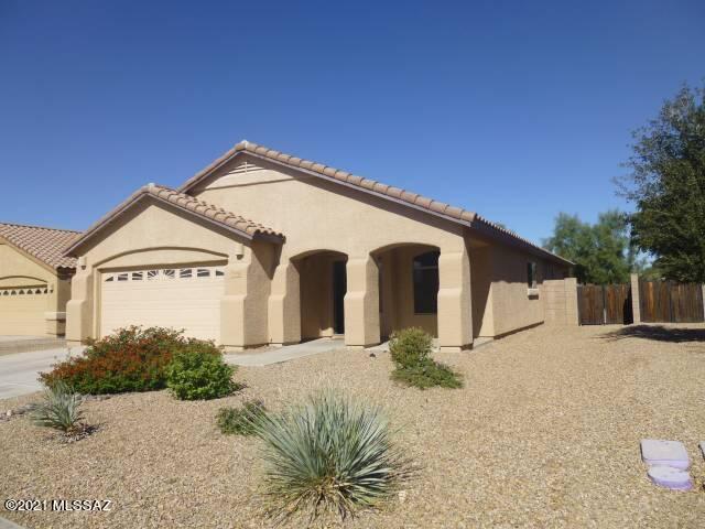 Like new home in Harvest Moon in Gladden Farms.  New paint, flooring, appliances including washer/dryer.  Four  good size bedrooms all with wooden blinds and fans.  Jack & Jill bath.  Split master with large walk in closet.   Each bath has garden tubs and dual sinks.  Large open kitchen to newly tiled family room.  Beyond is a covered porch with large walled yard.  Two car garage with opener.  Tile roof, dual pane windows and new screens.  Neighborhood has lights and sidewalks.