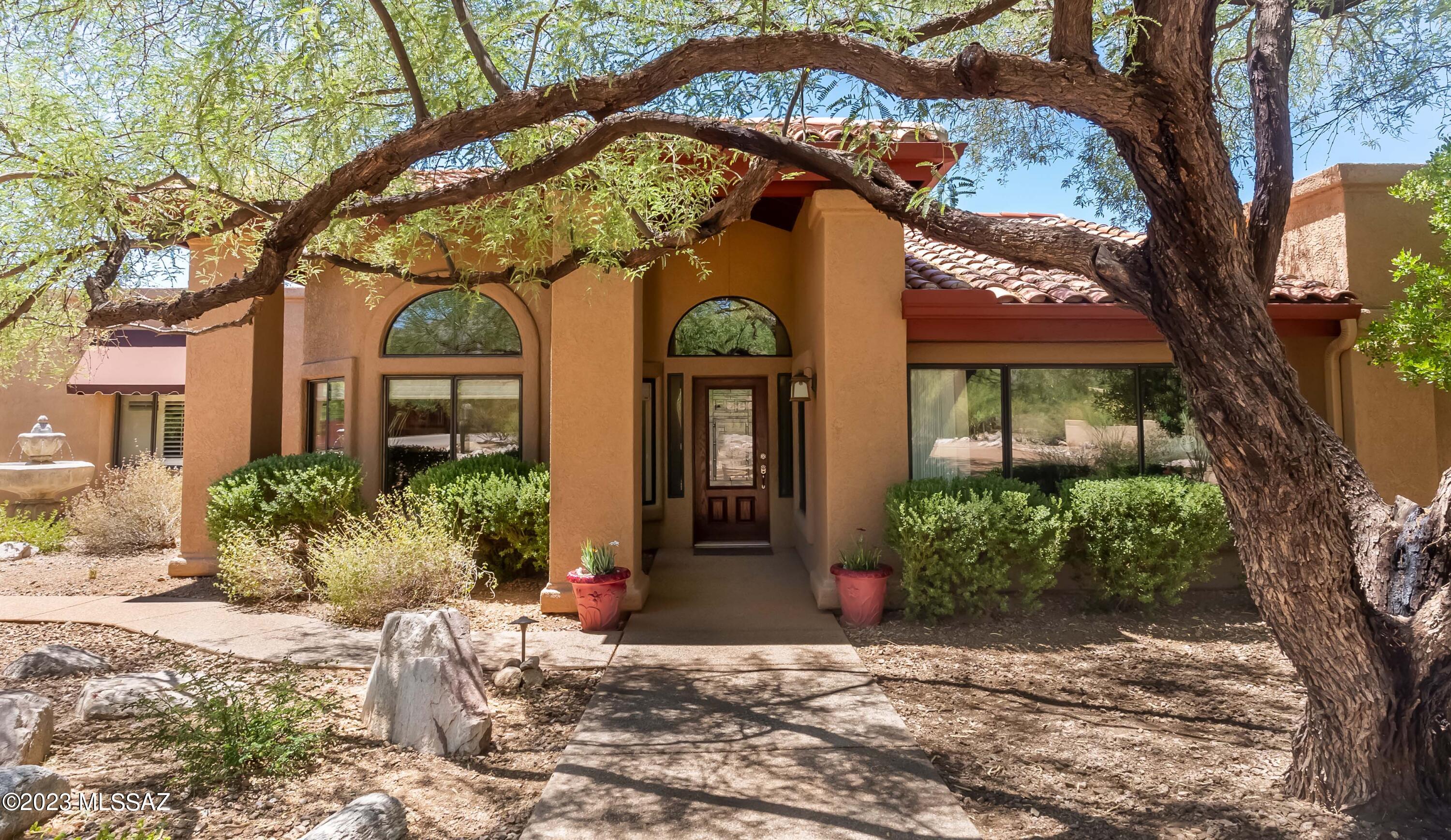 Welcome Home to this BEAUTIFUL property in the Tanque Verde Valley!  This 2977 sqft home on .9 acres features 5 spacious bedrooms, 3 full bathrooms, a 2 car garage, a 500+ sqft attached casita, and NO home owners association!  Mountain views in every direction, pool and spa in large, fenced backyard, and wide open space behind the home provide additional freedom and privacy.  Enjoy sunsets on your back porch's long, shaded patio, and follow the paved walking paths past your built-in BBQ, fruit-bearing citrus trees and firepit to watch horses behind your home in the pastures owned by the University of Arizona Ranch Management.  Mature trees provide shade over the lovely paved sidewalks and a fountain in front leading to your home's entrance, where the immaculately clean living space boasts high ceilings, open floorplan, all stainless appliances and island in kitchen, two unique living spaces, and inviting fireplace.   Spacious primary suite features additional cozy fireplace, large bathroom with separate shower and soaking tub, grand walk-in closet, and double sinks.  500+ sqft CASITA attached to the home, featuring kitchenette, bedroom, living space, and bathroom.  Three generous-sized guest bedrooms and bathroom in the back of home for additional family, visitors, office spaces, or flex rooms.  Water tank less than 6 years old!  Main house air conditioner less than 5 years old!  Carpet in all main house bedrooms less than 3 years old! Roof recoated 1 year ago and pool deck recently repainted!  All window coverings and appliances stay, including washer and dryer in laundry room!  Pride of ownership in this lovely property.  See it today before it is gone!