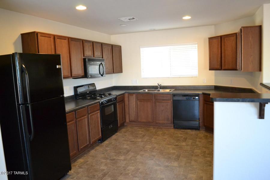 Clean as a Whistle, Neat as a Pin! Like-new 2 story with 3 spacious bedrooms and huge bonus room upstairs! Awesome kitchen opens to great room and features breakfast bar, loads of cabinets, and yards of counter space for preparing and serving yummy holiday dinners to friends and family. Black appliances including Gas stove for the gourmet chef, new refrigerator, easy to clean tile floors, extra storage under stairs. Nice backyard with extended patio and basketball hoop for the kids or the young-at-heart. Convenient to shopping, restaurants, schools, and I-10.