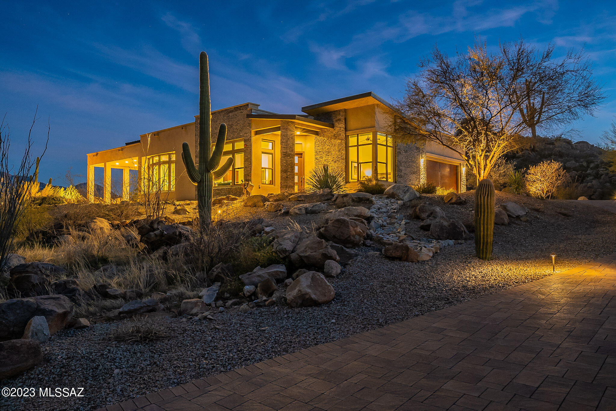 MOUNTAIN VISTAS. This magnificent home greets you with truly breath-taking views of the Santa Catalinas.  But few steps into the house, you feel the embrace of nature's majesty — a timeless grandeur. 
LIGHT AND SPACE.  Situated on a large elevated lot, this serene property features remarkable rock formations and a stunning desert landscape, including mature saguaros, and privacy.  With every window offering peaceful mountain and boulder vistas, soft desert light fills the house. At night, the clear sky makes distant galaxies visible.
GREAT ROOM.  The 16-foot ceiling, combined with a wall of of sliding glass, brings the spaciousness of outdoors into the living room.  That feeling of space carries into the kitchen, an entertainer's delight featuring an oversized quartz island for eating/ socializing, stainless appliances, walk-in pantry, and a wine bar.  The seasonally blooming red bird of paradise, complementing the saguaros, ocotillos, and rosemary, bring color into the dining area.
OWNER'S SUITE.  The suite looks toward the Santa Catalinas on one side, with a stunning boulder vista on the other. The bedroom is capacious enough for a sitting area or library.  The bathroom includes a large glass shower enclosure with both fixed and hand-held shower heads, dual vanities with generous storage space, and a separate water closet.  The voluminous walk-in closet accommodates storage beyond just clothing.
ENSUITE GUEST ROOMS.  The ensuite guest bedrooms (or rooms for live-in family) are located at the opposite end of the house, ensuring privacy for all.  Each has space for a reading chair and a small desk.  And both have walk-in closets with storage for clothes and suitcases.
READING ROOM/DEN/OFFICE.  Next to the entry, there is a space with a view sweeping over the neighborhood, boulders, and cacti. In its current configuration, it serves as a reading room.
METICULOUSLY MAINTAINED. The seller has discerningly maintained and improved this home, including installing automated window coverings, Reme Halo medical-grade air purifiers on both HVAC units, and epoxy flooring in the garage.  For the owner's peace of mind, the house was professionally sealed in 2022 by Seal Out Scorpions, which to date has also been 100% effective against spiders, insects, and centipedes.
NEIGHBORHOOD. While atop its own hill and so above other nearby residences, this home is located in an especially welcoming, friendly area of Stone Canyon called Boulder Vista, where the occupants of its 36 homes gather for an outdoor potluck at least a couple of time each year.
STONE CANYON.  Situated in beautiful Oro Valley, Stone Canyon stands out as the epitome of luxury living.  The world-class golf course, designed by Jay Morris, ranks in the top 100 courses in the US, the only such in Arizona.  The health and fitness center, pickle ball and tennis courts, pools, spa, and a clubhouse with a restaurant and bar, and entertainment programming, round out the resort-style living experience.