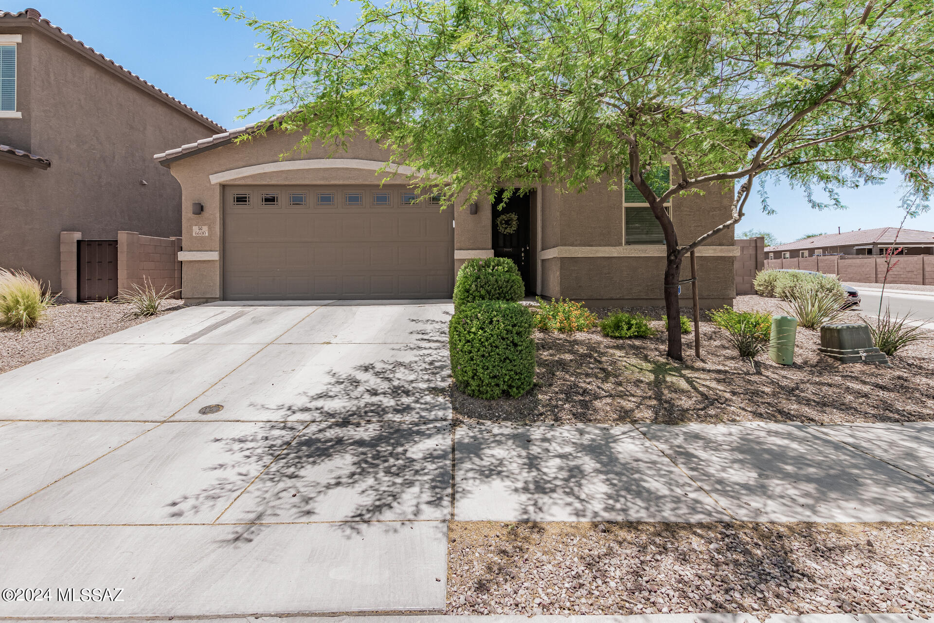 Pride of ownership is shown in this remarkable corner lot property nestled in La Estancia De Tucson! Discover a bright, spacious open layout showcasing tile flooring, a soothing color palette, recessed lighting, and multi-sliders leading to the back patio. The fabulous kitchen boasts a plethora of white cabinets adorned with crown molding, a stylish tile backsplash, sleek granite counters, a pantry, stainless steel appliances, and a center island complete with a breakfast bar. The primary bedroom offers soft carpet in all the right places, a private bathroom with dual sinks, and a walk-in closet. The extended garage allows ample storage space even with your vehicle parked! Spend relaxing afternoons along with your loved ones in the charming backyard with a covered patio.