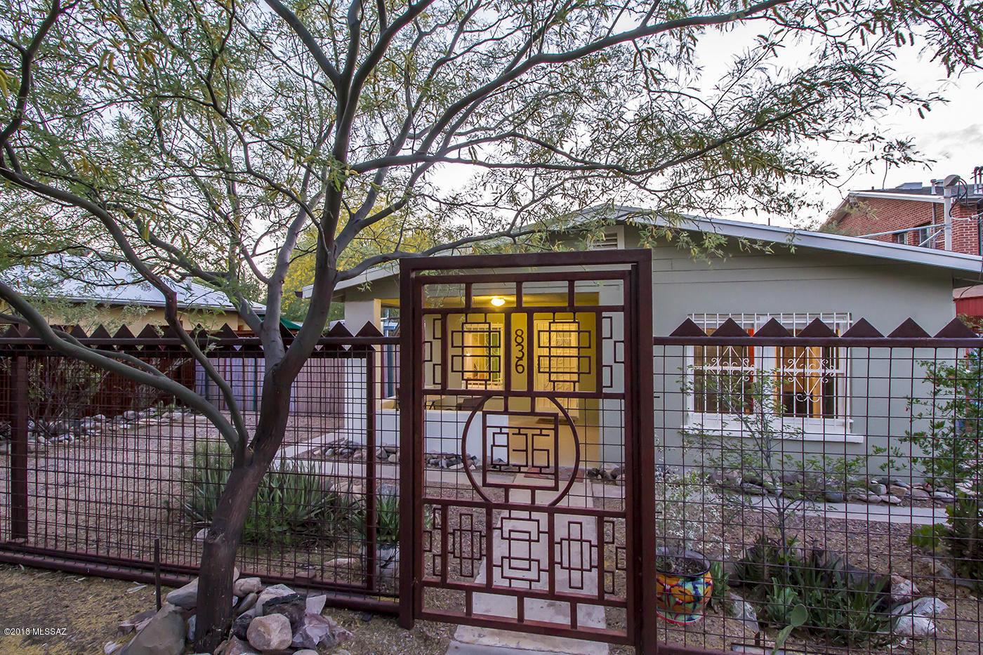 Welcome to the Wonderful World of the Historic Dunbar Spring Neighborhood and its eclectic & rich history. Walk, Bike, or Street Car anywhere your adventurous spirit takes you. Downtown, 4th ave, U of A or the Mercado. The c.1929 Bungalow sits in the heart of the neighborhood retaining its historic charm and character with wood floors and double-hung windows. While being tastefully updated with large open kitchen, remodeled subway tiled bath and ceramic tile floors. New roof in 2017. An 800 gallon water harvesting tank to hydrate the low care native flora consisting of flower gardens, cacti and succulents. Ramada's & a workshop complete the backyard landscape. Amazing metal work on the fences lends personality and rolling gates for off street parking. OPEN HOUSE Saturday May 5th 11-3
