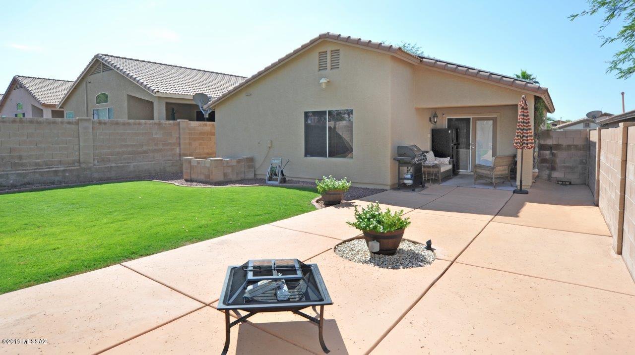 Superb East Side Location! This 4-bedroom, 2-bath home has been meticulously cared for and is move in ready! Spacious great room w/vaulted ceiling and kitchen boasting recessed lighting, granite counters, maple wood cabinets, SS appliances, and a pantry closet. Split floor plan with an oversized master suite, walk in closet and a new deluxe walk-in shower with E Stone surrounds, barn style glass doors, rain shower head, niche lighting, and double sinks. French doors draw you outdoors to a beautifully landscaped yard with covered patio and an extended height wall for complete privacy! TEP owned solar panels, but maintained by TEP, water filtration system, soft water system, exterior painted less than 4 yrs ago, hot water heater less than 2 yrs. Don't miss this one!