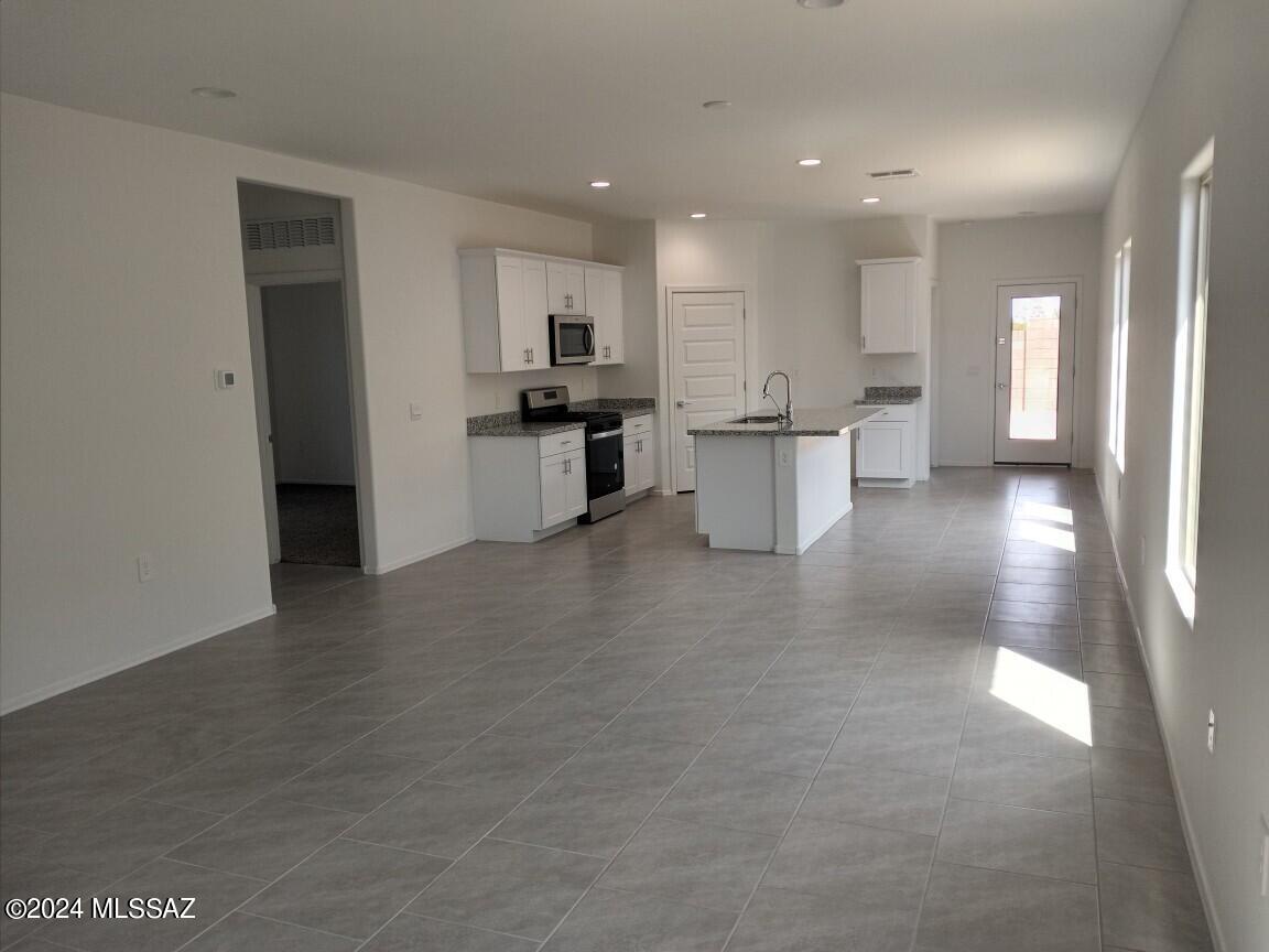 Ready to move?  This home be ready for October close.  Come see this open-concept floorplan.  The kitchen has a spacious island with white cabinets, granite countertops, a gas stainless range, a built-in microwave, a corner pantry, and LED lighting. Also18x18 tile everywhere but bedrooms, dual vanities in the primary bath, 9' ceilings, covered patio, tankless gas water heater, and lots more. Technology suite included!
