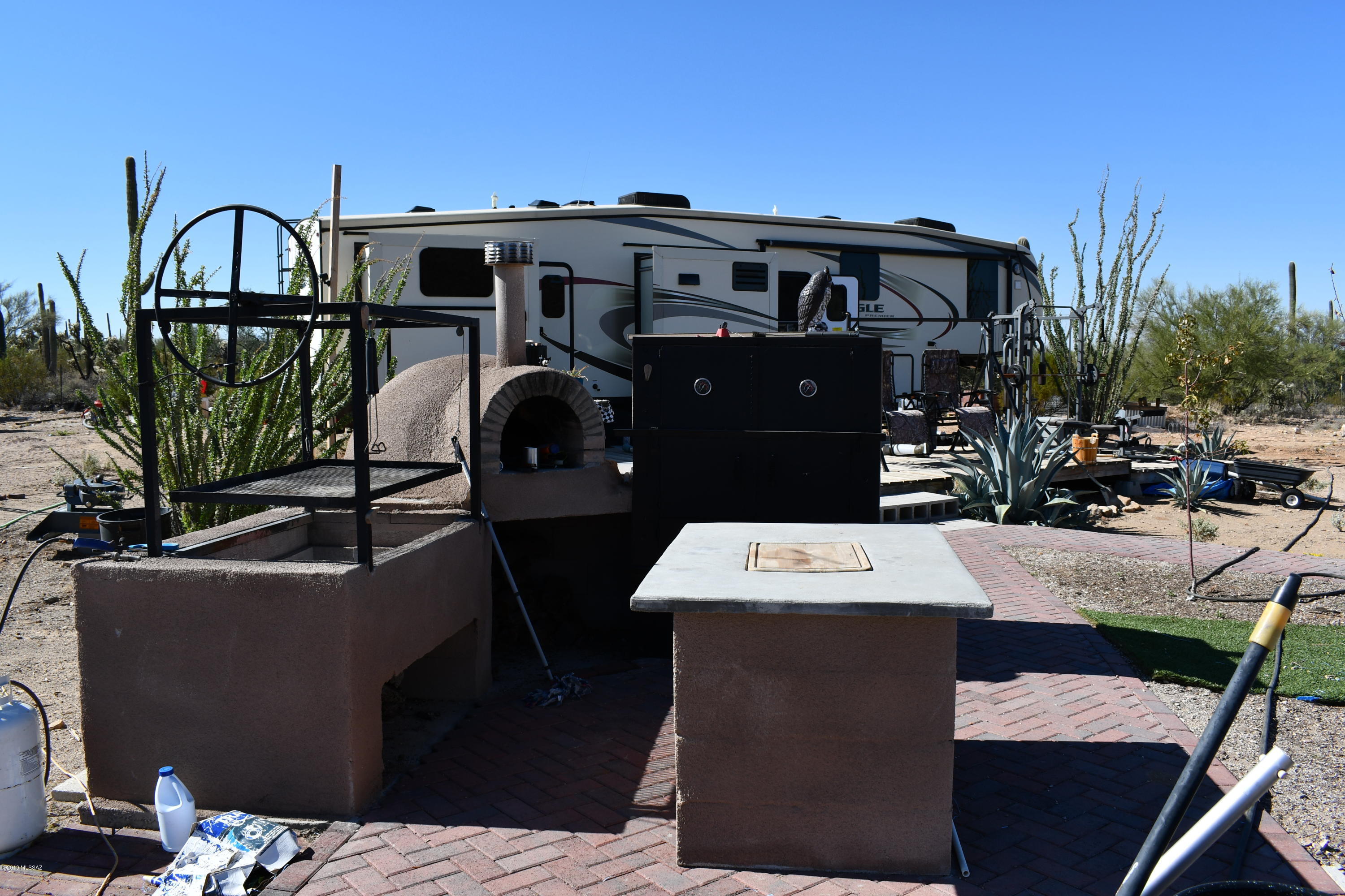 Almost two acres situated 1/4 mile outside Saguaro National Park. Quiet country setting with panoramic views of majestic saguaro and picturesque mountains. Property is partially fenced with electric firepit perfect for entertaining on those clear desert nights. Greenhouse with three watering zones, tomatoes and peppers on the vine. At this time, property has a 5th wheel residence that will be removed as well as all personal property at time of sale. Storage containers available for sale. Property is zoned for homes, mobile homes and horses. Close to trail system in Saguaro National Park. Owner hauls water, however, Avra Water is now available.