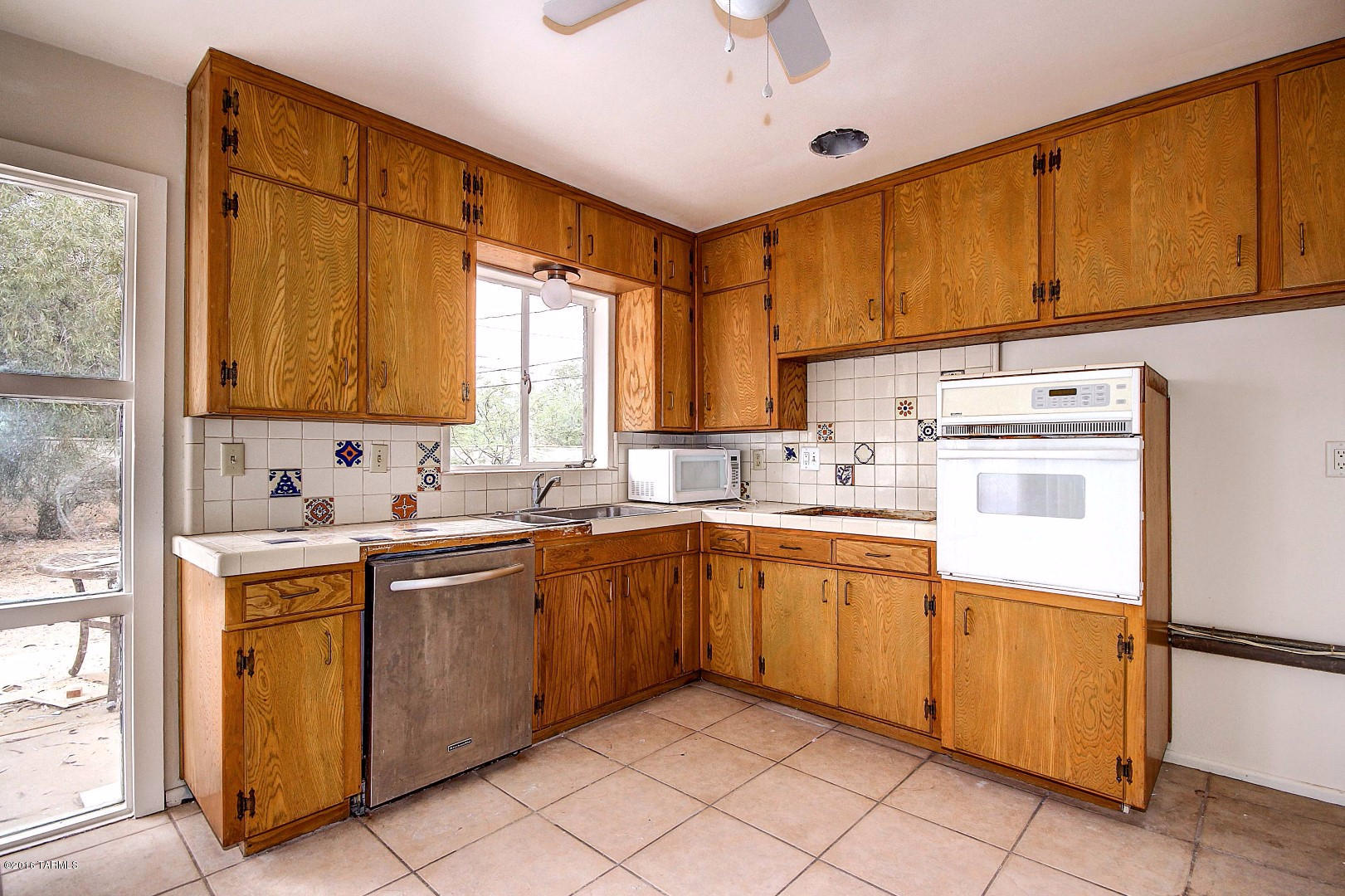 Bring your Imagination and Creativity to this 1950's Home with a lot to offer. Huge lot with shade trees and room for a pool! Ceramic tile floor t/o, ceiling fans, picture window, and unique front door. Formal dining area with French Door to patio. Spacious eat-in kitchen wit lots of natural light. Generous size bedrooms and bathrooms. Large utility room with sink and cabinets. This charming Home is need of TLC and can become the ''envy'' of the neighborhood!