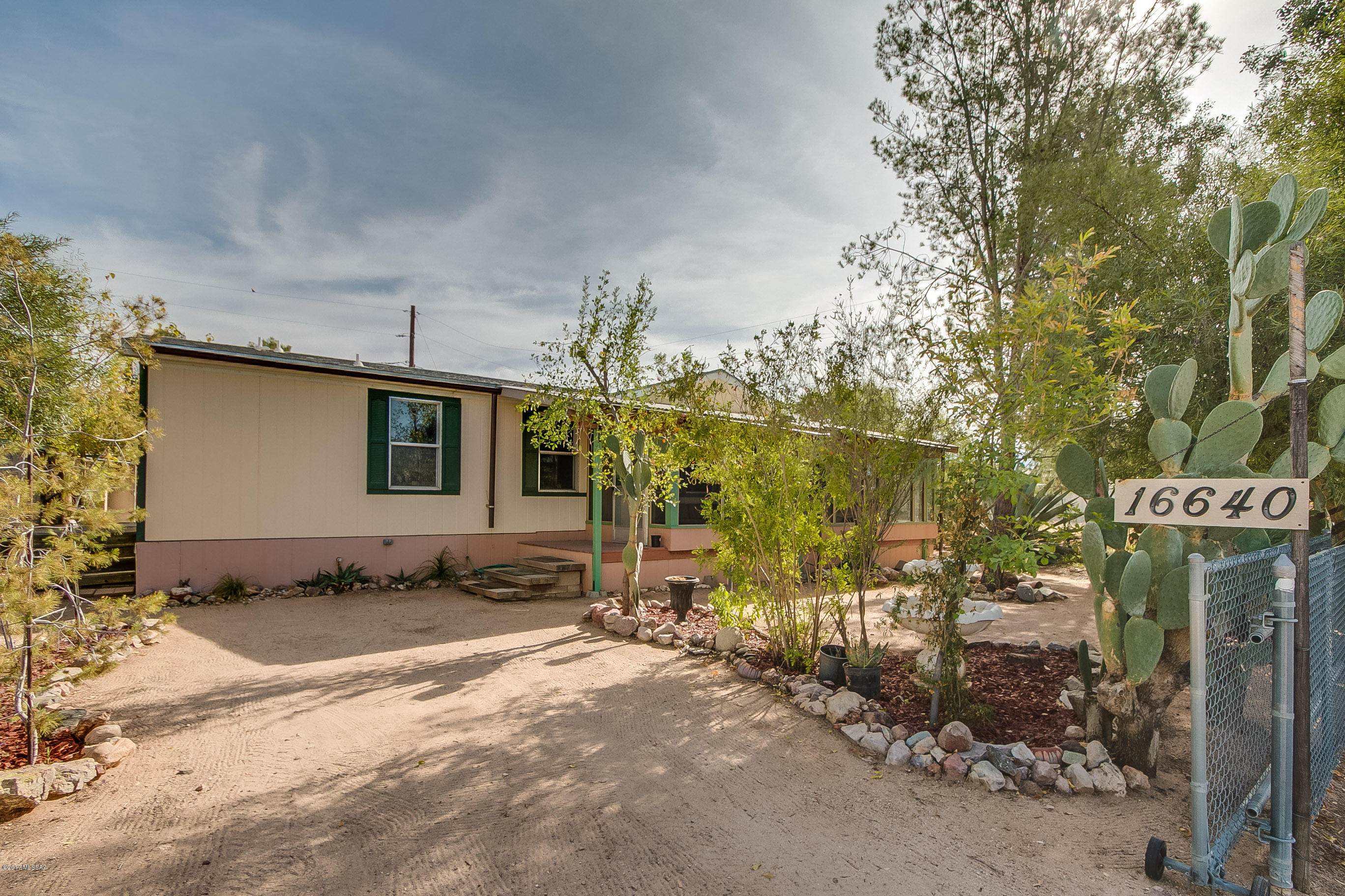Don't miss out on this unique property, located in the heart of Catalina. This beautiful 1,344 sqft manufactured home provides the owner with tons of storage inside and out. Luscious trees help seclude the property and add privacy. The backyard comes with a workshop and pottery shed. Total of 6 sheds on property. Spacious open floor plan with split bedrooms.