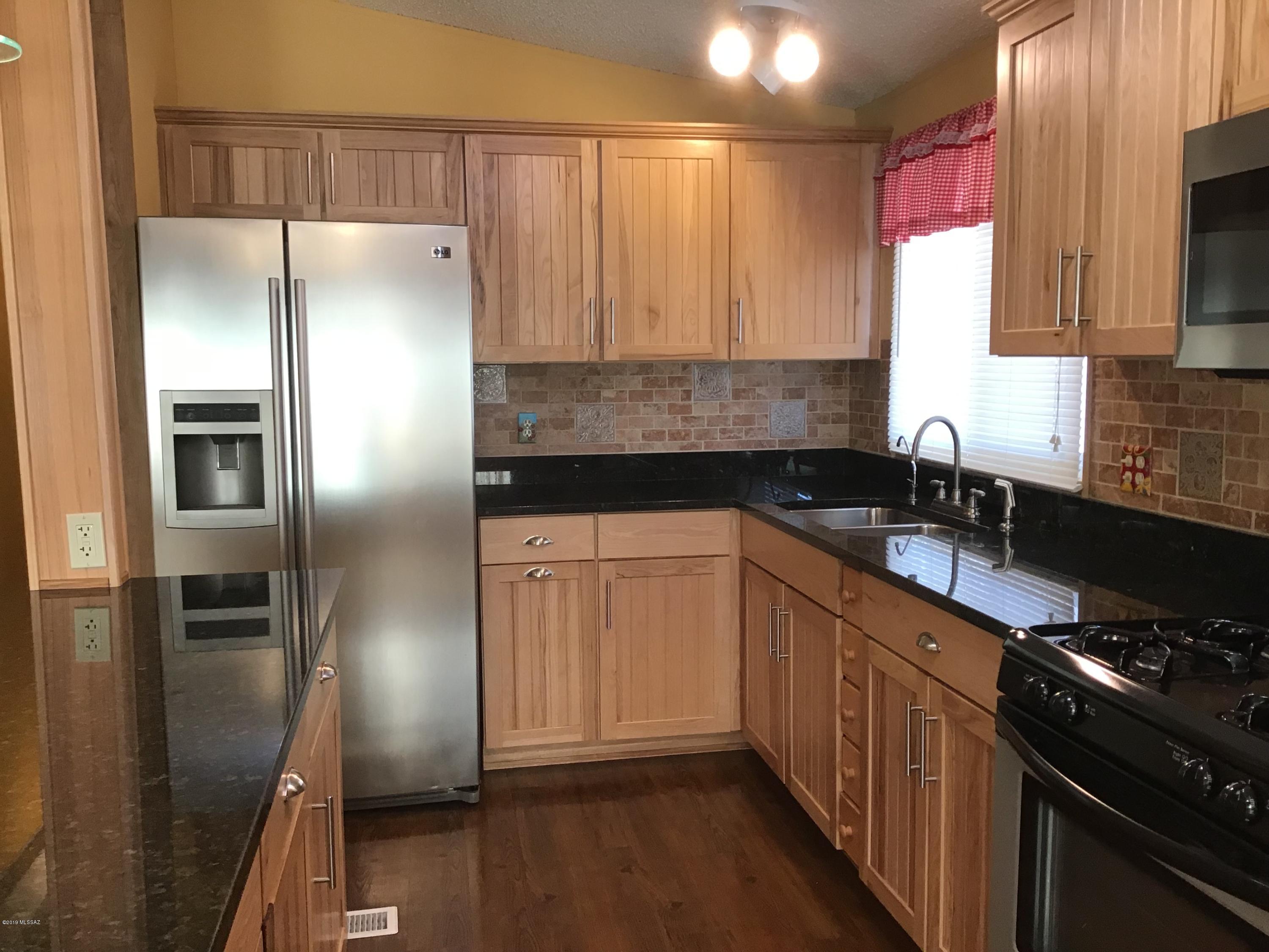 Well maintained home with lots of extras. Home features kitchen with new cabinets and  slide out shelves, granite counter tops, SS appliances including new overhead microwave, vinyl plank floors, separate dining area and 265 sq. ft of enclosed porch addition. There's a workshop with workbench plus 2 separatestorage rooms. Ceiling fans throughout and dual pane windows. If you like to interact with others, this community offers a pool, spa, shuffle board, exercise room, library and lots of events in the clubhouse. HOA is low and includes trash and amenities. No GVR but is available! Great neighborhood in a very nice community.