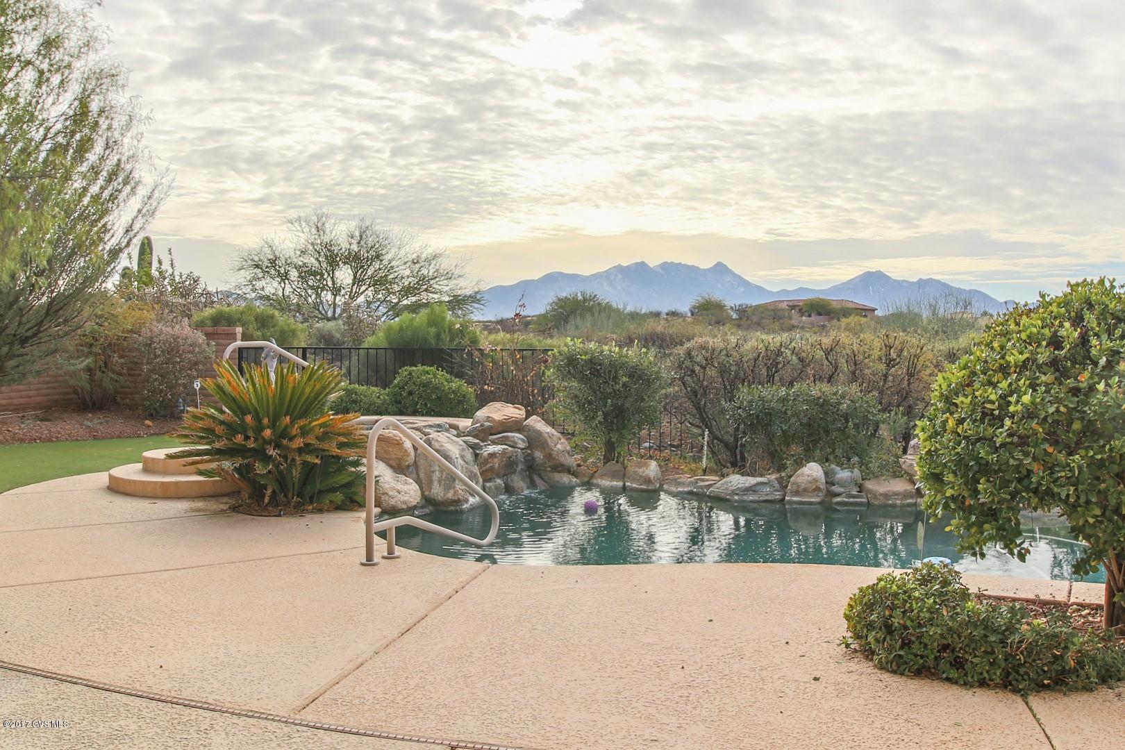 UNOBSTRUCTED VIEWS of the stunning San Rita Mountains from your back patio, great room, kitchen and master bedroom. Great room concept with open spaces for entertainment. Two bedrooms plus den, two full bathrooms. Home sits .43 acre, cul-de-sac for added privacy. Pebble tec pool and spa and putting green. Fresh interior paint and new carpet in bedrooms. GVR available.