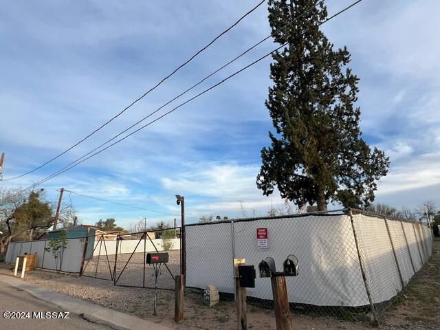 Fenced property, zoned multi use
Electric and water on property
No Sewer connected
 Gravel Lot and gate
Access from Alley