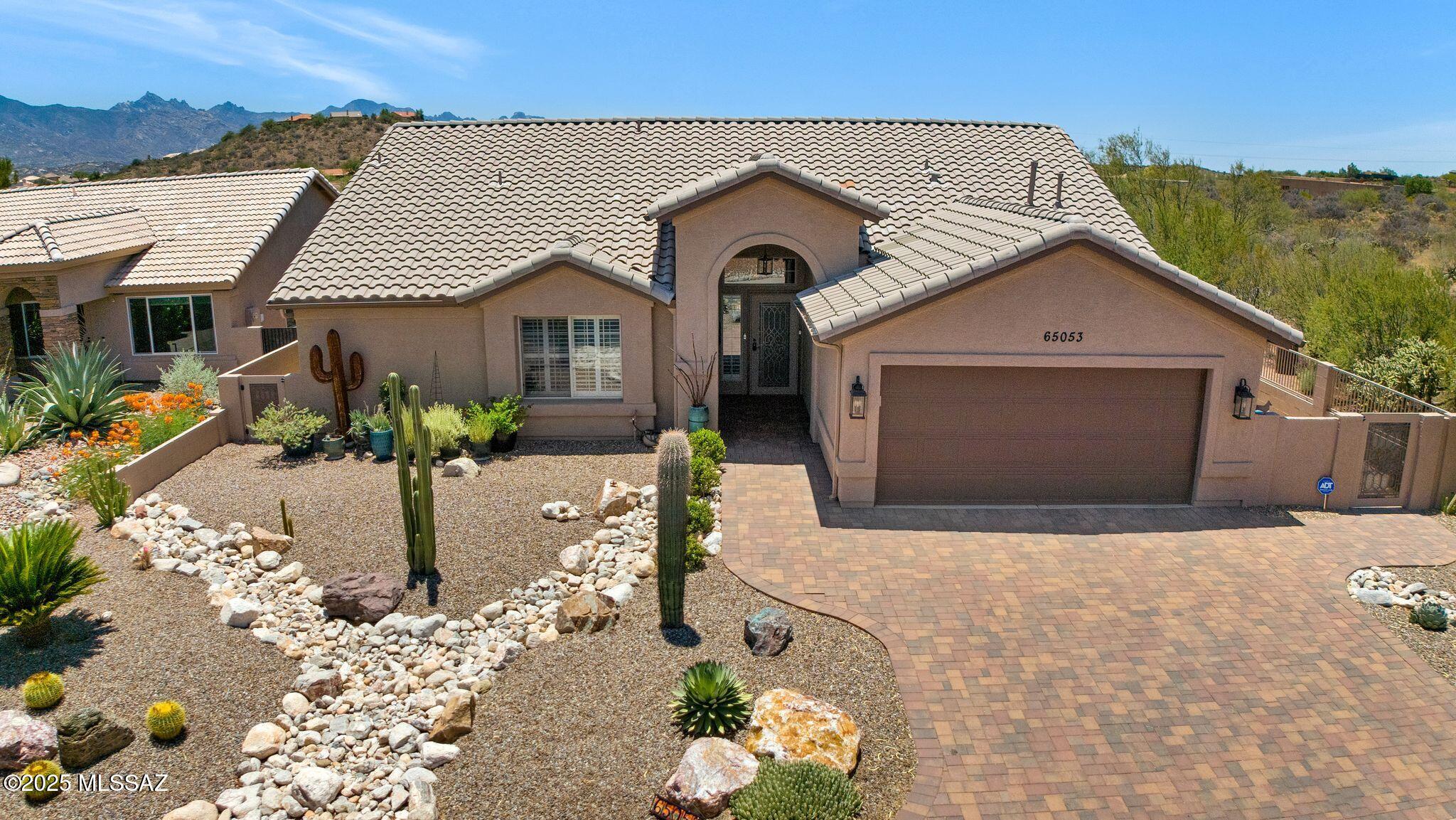 Sedona with Mountain Views, Nature Behind & on Right Side of home. Great Curb Appeal! Paver Driveway & Paver Sidewalk lead to Custom Entry Door. Great Room & Dining Area with Slider to Patio. Kitchen has Granite Counters, Slate Appliances, Abundance of Cabinets, Island & Walk-in Pantry. Large Owner's Suite with Mini Split. Owner's Bathroom has Dual Vanity, Soak Tub, Walk-in Shower & Walk-in Closet. Spacious Den that could turned into 2nd Bedroom. Guest Bathroom has Walk-in Shower. Tile Flooring & Plantation Shutters thru-out plus Central Vacuum System. Laundry Room with W/D & Cabinets. 2 Car Garage has Large Utility Sink & Cabinets. Covered Paver Patio with 2 Rolling Shades. Extended Paver Patio has Pergola. Gated Yard with 3 Fruit Trees & Lovely Landscaping. Just the place to call home!