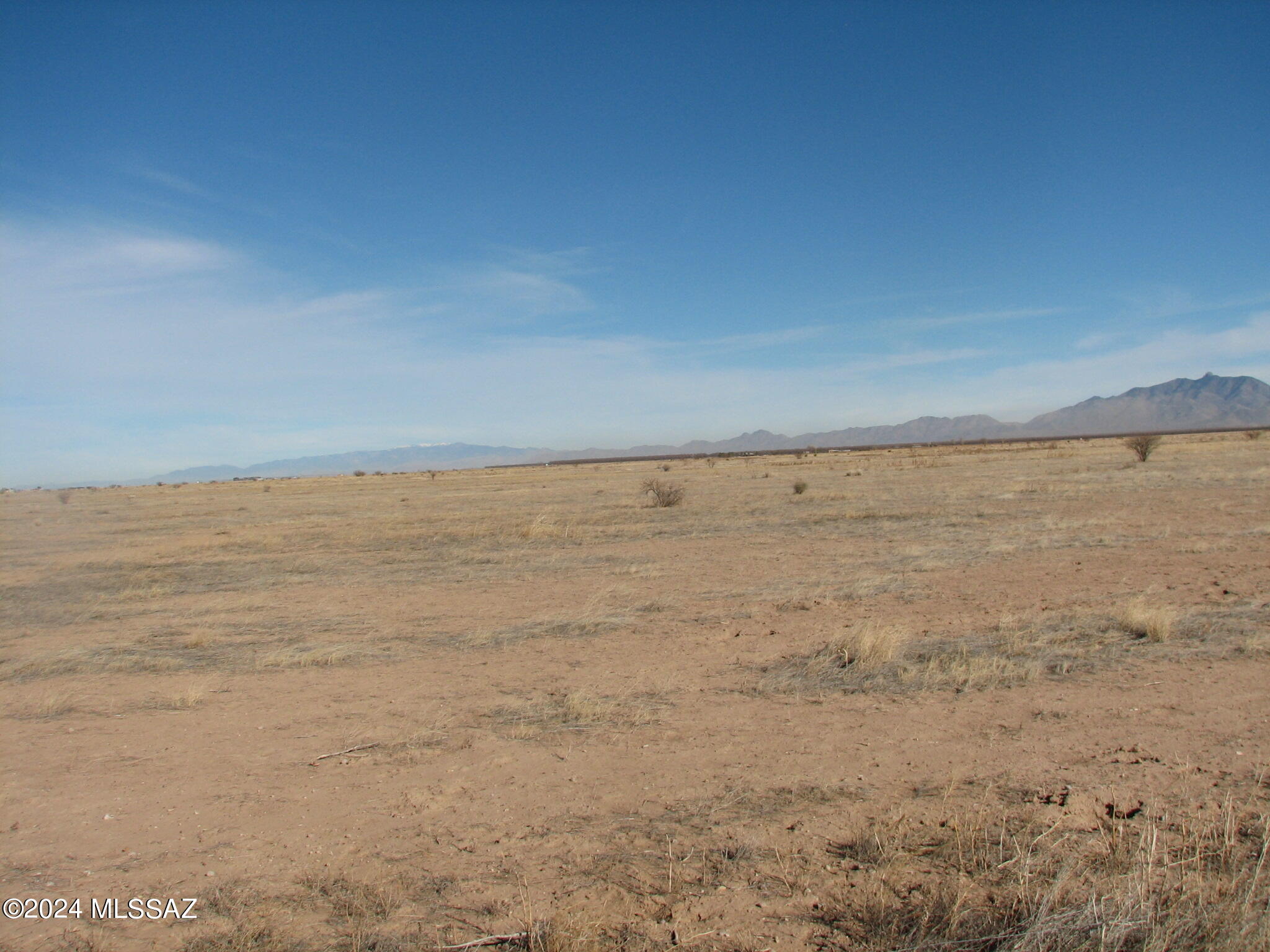 Scenic, level land in the Sulphur Springs Valley.   County maintained, hard surface road frontage.  Electric and telephone on Parker Ranch Road.  Adjoins proposed new AI Data Center.  Ideal for your country home and horse ranch !Sweeping views of the Valley, the Dragoon Mountains, Chihuahua Mountains and the Dos Cabezas Mountains.