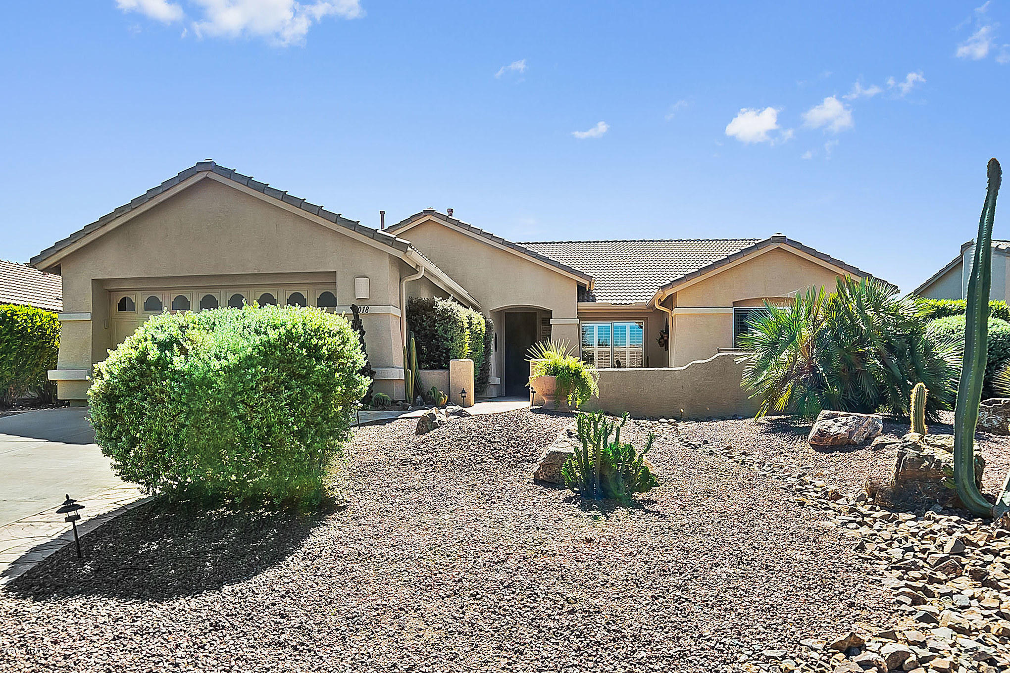 This home exhibits top quality beginning with crisp desert landscaping framed by decorative rock and brick pavers, plus a front courtyard with giant colorful flagstone. You will enter into a peaceful and serene living room with big twin picture windows overlooking your lush backyard greenery. And, the oversized floor tile, cathedral height ceilings, open formal dining area and beautiful hardwood flooring in the den demonstrates true pride of ownership. Step into the stunning kitchen with its above cabinet up-lighting, stainless steel appliances including a double door refrigerator with pull-out drawers and an easy clean glass top range. The island snack bar with its under counter sink accented by gorgeous solid granite counter tops is designed to serve the convenient bay window dining area where you can relax and enjoy a quick meal. The family room with built in media center and shelf lighting is where you can display your favorite art and sculptures. Your master bedroom sanctuary features a custom ceiling adding depth and character while the full wall length bay window takes center stage and draws in the backyard views. Your master bath provides a shower with beautiful custom tile work and the executive height vanities demonstrate superior taste and design. Enjoy time in your screened-in patio to enjoy fresh outdoor air while remaining clear of the elements. A large covered patio is certainly a place where you will spend time enjoying the botanical dream gardens bordered by green grass and slate walking paths. The home of your dreams!