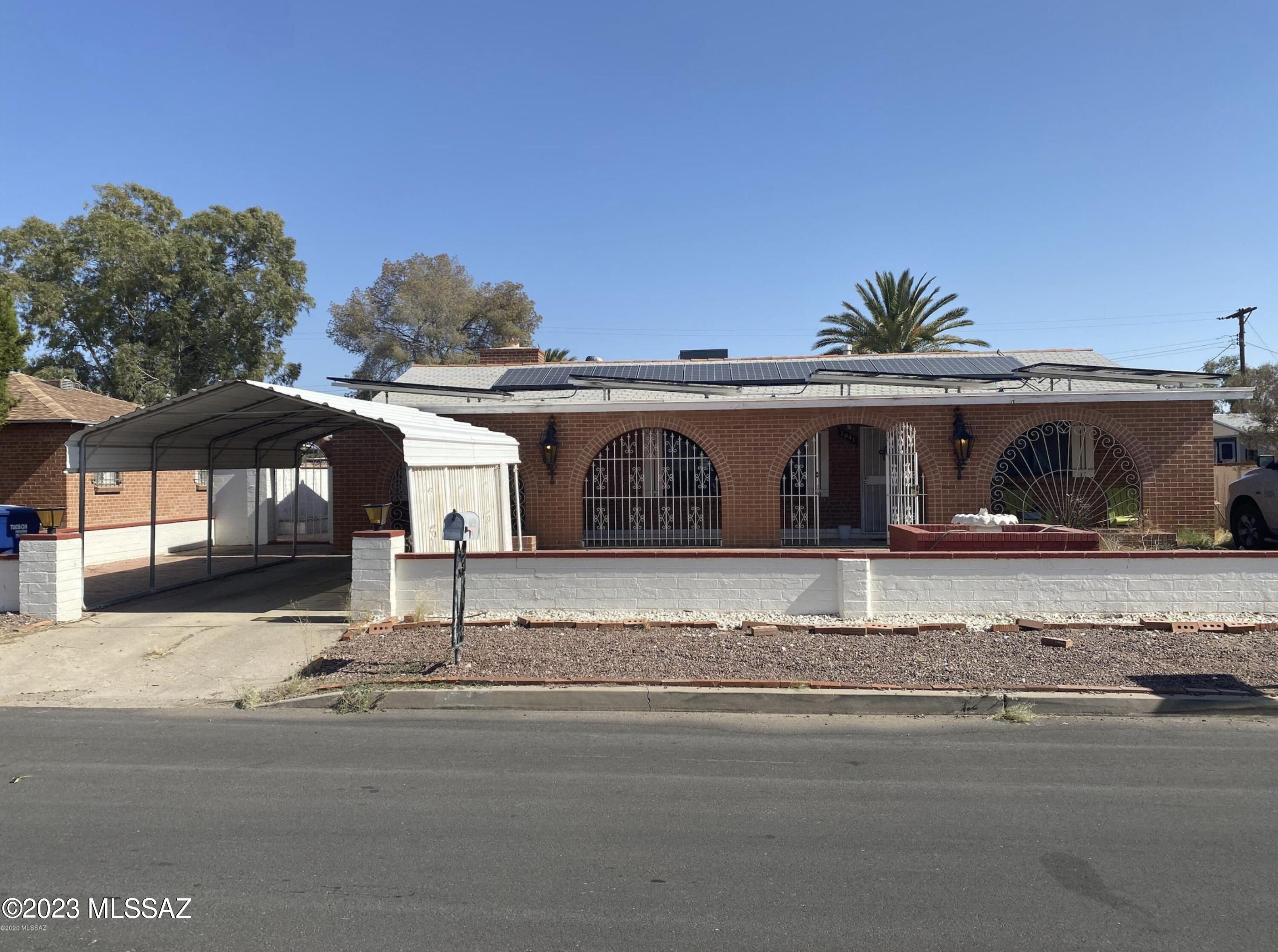 Beautiful unique red brick home located central!
Less then 5 minutes from downtown under 10 mins to the U of A! This amazing property features newer AC unit and newer Water heater, carport, gas stove, a must see large backyard with concrete slab, block wall surrounding both front and back yard, it has a heated/cooled Arizona Rooms, laundry room, raised brick flower beds, and gated front seating area! Buyer to qualify to assume Solar panels on the home. Home sold as is.