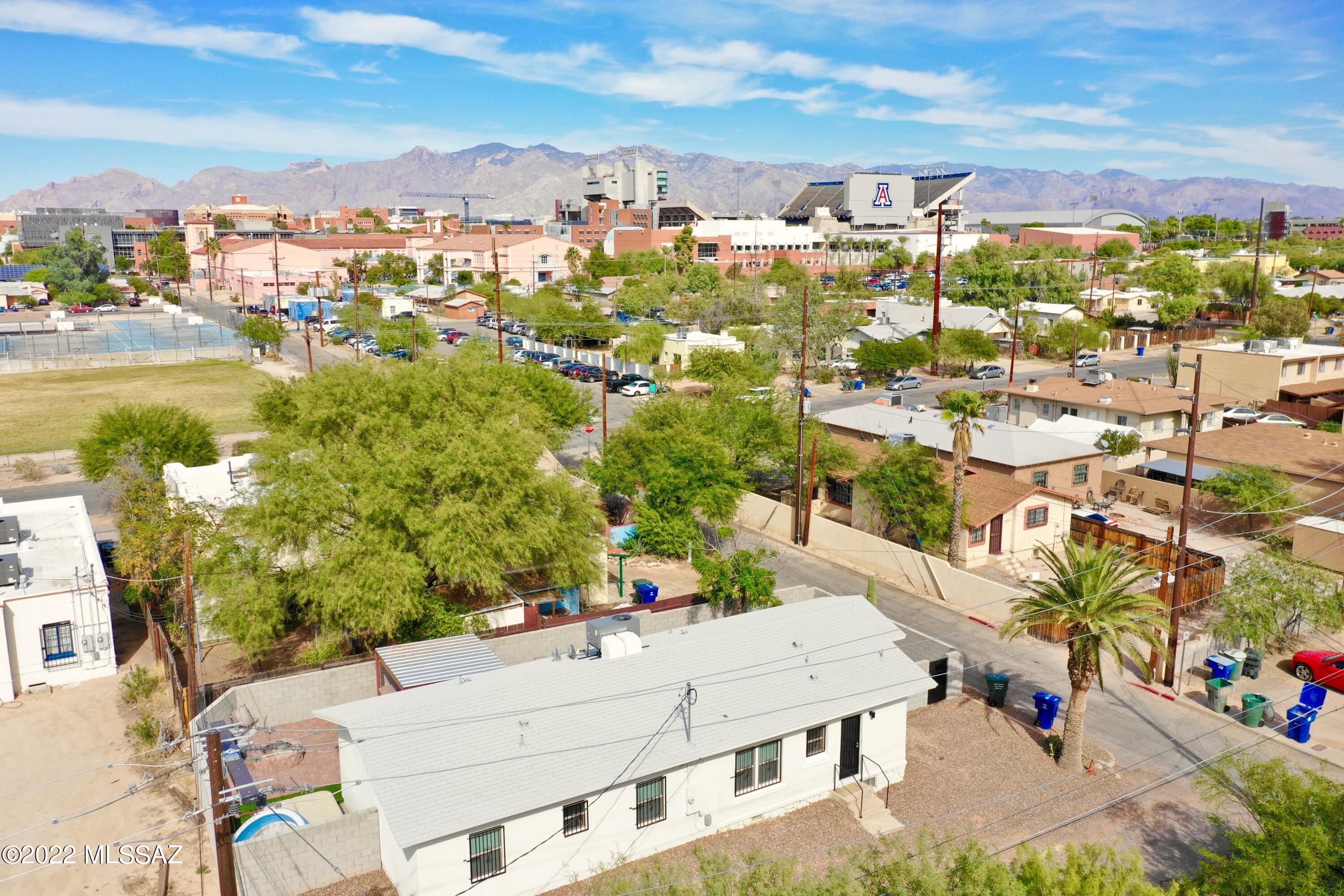 This student rental property was beautifully remodeled with new addition in 2018. This property was built with the student in mind and should be a desirable rental property for many years to come. The backyard is fully landscaped, including artificial grass, fire pit, BBQ patio and bar, & Jacuzzi. Property if fully leased through JULY 2023! Located two blocks south of the UofA campus! This turnkey property professionally managed by Tucson Integrity Realty is ready for an investor.