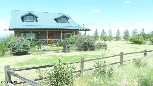 Authentic Ranch Loft home designed for the wild west enthusiast! Terrific horse property offers bushels of charm! Sensational views spreading across the Sonoita Valley encompass Canelo hills, Huachuca's & Whetstone Mountain ranges are simply electrifying! A variety of 200 planted trees, irrigated orchard, decorative fencing, old fashion style water fall & charming flowers/shrubs envelop the grounds. Large cultured stone wall surrounds a warm glowing Gas FP in open lodge style Great room. Spacious country style kitchen w/large ceramic tile & knotty pine flooring, tongue/groove ceilings will bring out the western spirit in all who enter. Enjoy relaxation inside screened-in porch or watch sunsets from elevated deck. Large fenced pasture w/hay storage & ability to ride out to nearby Forest.
