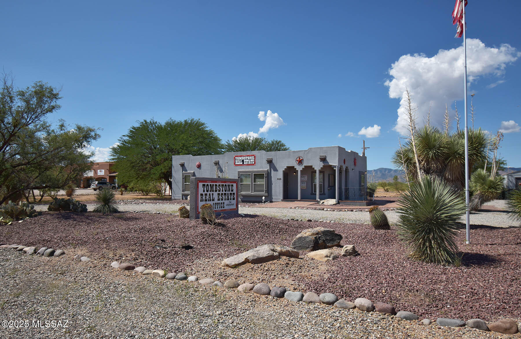 Custom-built Santa Fe style modular office building on 1.11 acres with 1,530 sf of versatile space; formerly a real estate office but easily adapted for business or single-family use. Located on a corner lot along Frontage Rd just off Hwy 191, this property offers high visibility and growth potential, especially with the planned Port of Entry in Douglas expected to boost traffic and investment in the area. Bright open reception area with abundant windows, break room, two private offices with storage, plus a spacious conference room/office. Large back porch has outstanding views of the Dragoon Mountains. Big one-plus acre lot gives you lots of space to work with. Matching storage shed included. Strong location, solid construction, and unlimited possibilities.
