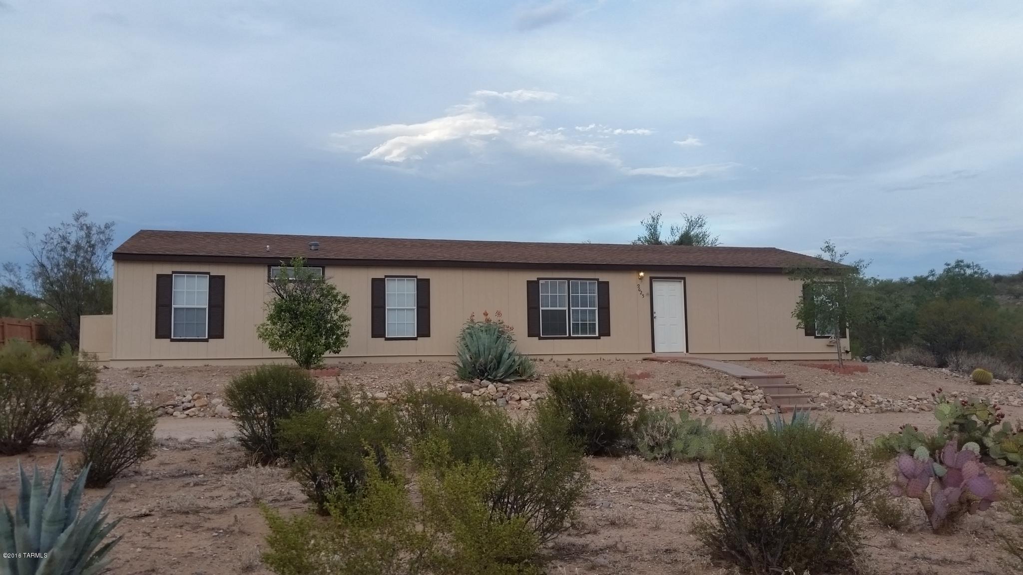 Seller will accept or counter offers between $99,900-$109,900. Pre-inpected and all repaired, including new roof (see attached list). Enjoy the openness of the living room's vaulted ceilings as it flows into the brand new kitchen with a custom island, wainscoting, wood floors, and numerous skylights. Separate family room with fireplace is a perfect place to relax after a long day's work. Master bedroom and bath are on the other side of the home with a large walk in closet and dual vanities in the bath. With over an acre of land, there's plenty of room to spread out, but the back yard has a wooden fenced area that can afford privacy and enjoyment while keeping out most desert wildlife. Very easy access to Pantano Wash for horseback riding, and wonderful views