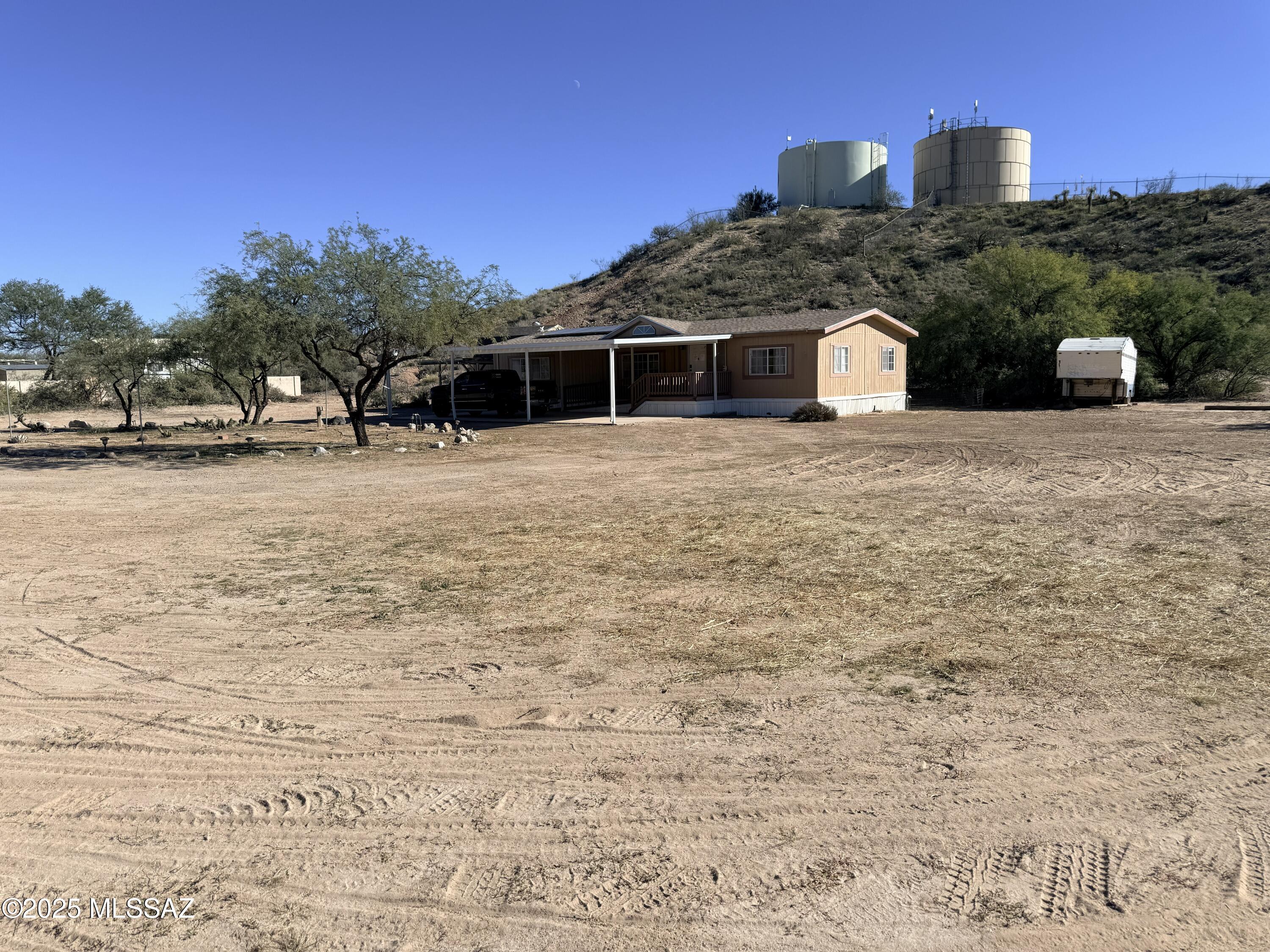 3BR/2BA home on nearly 1 acre in Benson. Split floor plan with open living area, large kitchen and spacious primary suite with large walk-in shower, Detached carport with storage, circular driveway with covered parking pad and beautiful mountain views. Comfortable home with plenty of space inside and out.