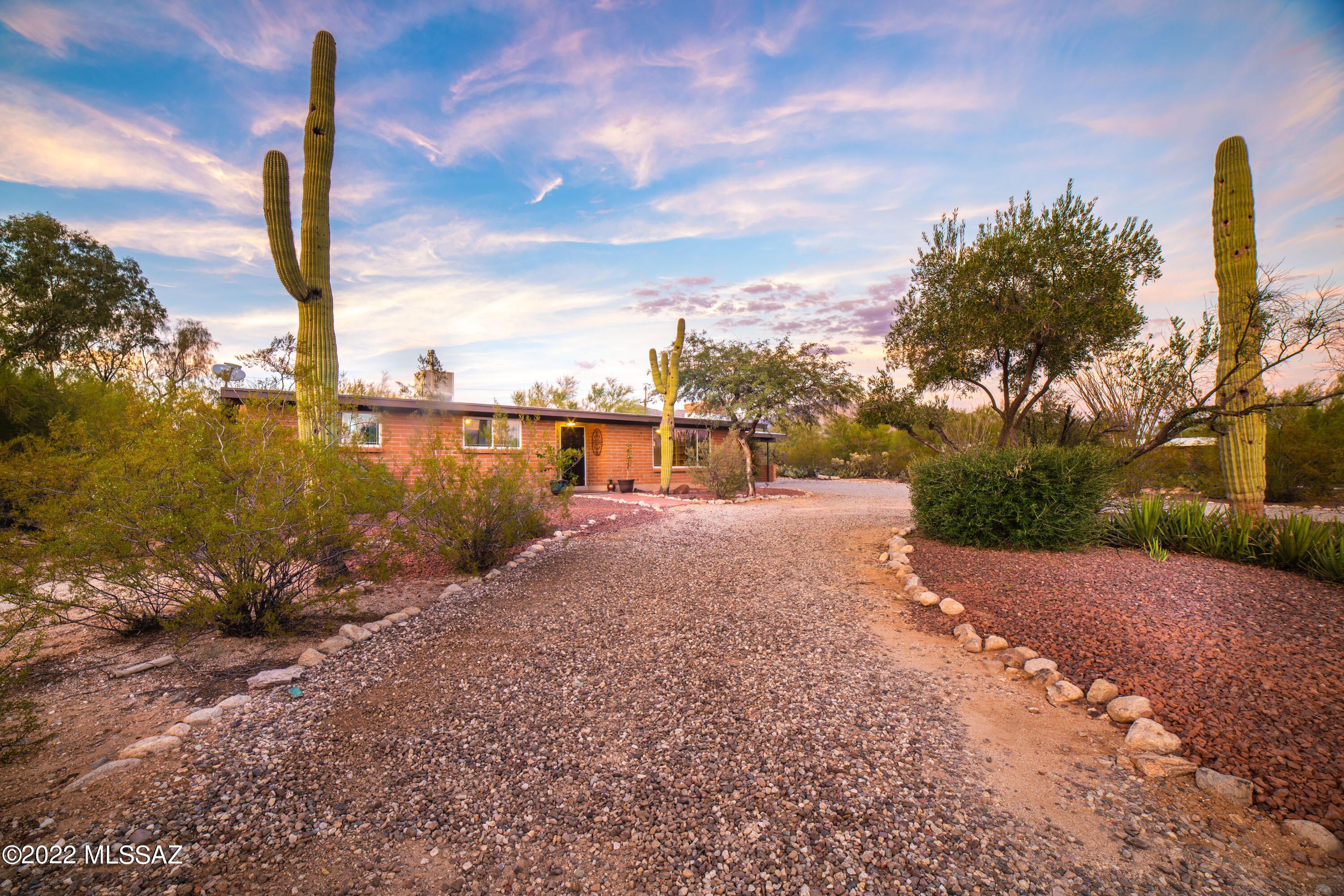 Charming and beautifully updated mid-century brick home in the coveted Casas Adobes Casas Catalinas neighborhood. 3 br/2ba home situated in a quiet cul-de-sac with lots of privacy and beautiful views of the mountains.  Enjoy the sunsets from the front yard and entertain your guests in the backyard gazebo. The updated kitchen with granite counters is bright and open to the dinning area. The French doors provide a beautiful view of the well manicured yard with mature mesquite and palo verde trees, truly pride of ownership. NO HOA