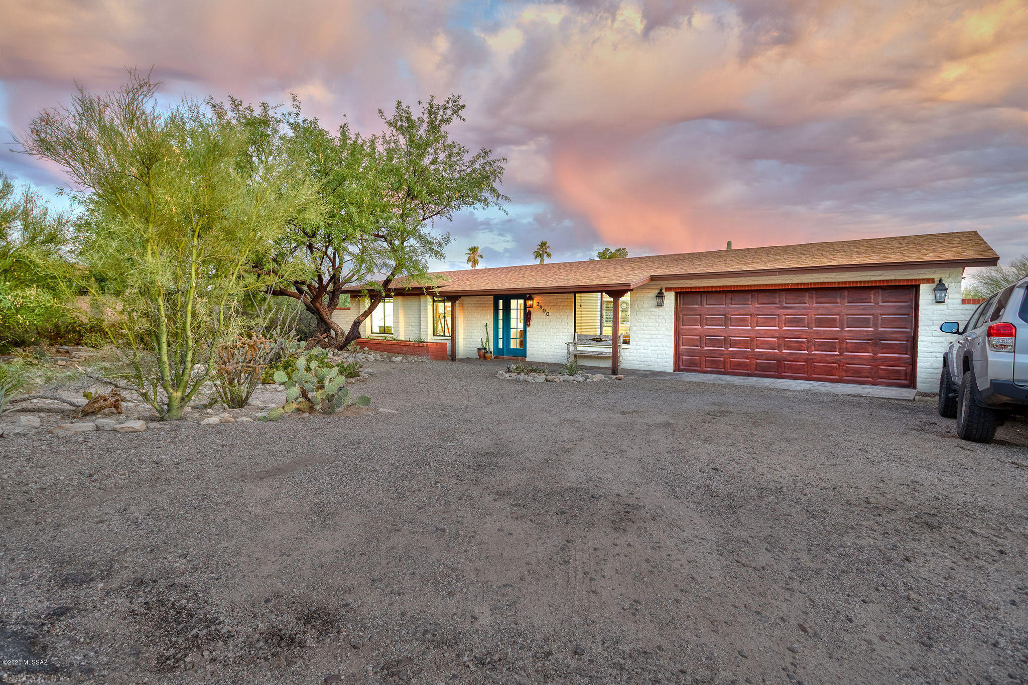 Updated modern Southwestern ranch with omnipresent Catalina mountain views. Move in ready 2,034 SqFt, all electric 4 bed/2 full bath split floor plan, attached two car garage sitting on organic native desert landscaped .37 acres premium corner lot in the desirable Foothills Clusters. Single story, no stairs/steps, Catalina Foothills School District, N/S orientation providing both city and dramatic Catalina mountain range views. Updates/features: Architectural shingle roof, copper plumbing, fresh paint inside and out, hand textured Navajo white walls, textured ceilings (no popcorn), energy efficient double pane windows, low maintenance tile & concrete floors, modern matte black fixtures and hardware, updated light fixtures, genuine wood internal doors and trim, custom wood blinds CONTINUE ceiling fans, digital thermostat, updated high efficiency toilets, remodeled full guest bathroom with walk in pebble floor tiled rain water shower, modern wood vanity, open concept kitchen with massive full slab granite counters, bar seating, custom hammered copper deep kitchen sink, recessed lighting, exposed wood beam, new modern plank wood cabinets/pantry, raw edge wood shelves, custom plaster exhaust hood, open to formal dining area with fantastic natural light. Treat yourself with grand master suite complete with modern Mediterranean inspired remodeled full master bathroom with crisp white quartz dual sink modern vanity, smooth stucco rain shower and vast walk in master closet w/wood shelving. Enjoy master access to covered wood plank covered patio on elevated concrete slab with expansive Tucson desert, tranquil sunsets and city light views. Low maintenance natural desert backyard includes walking trails, mature vegetation, saguaro cactus, palo verde, mesquite, agave and prickly pear cactus. If you are searching for a move in ready home in the 85718, make sure to book your appointment to view this value priced home today.