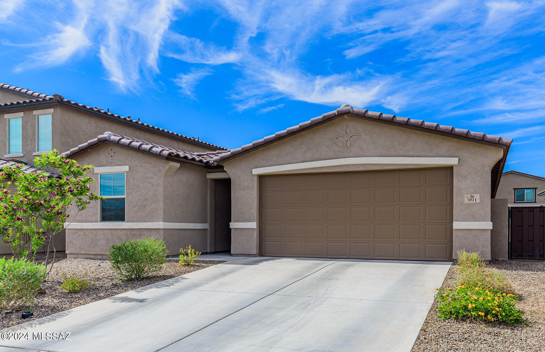 3.875% Assumable VA loan available for non-veterans! Entrada Del Rio!  Rancho Sahuarita! This immaculate 1790 SF single story home features 4 Beds, 2 baths!  Great room concept!  Wood look tile flooring throughout with the exception of front 2 bedrooms!  Modern kitchen features quartz countertops, white cabinets, black appliances and coffee bar area!  Large tiled Primary bedroom features walk in closet, primary bath showcases quartz counter tops, dual sinks, and large walk-in shower! Split bedroom plan!  Tiled bedroom 2 makes perfect office, sitting area or even a home gym! Backyard is a blank slate just awaiting your artistic touch! Rancho Sahuarita community features clubhouse with gym, water slides, community pools, lake and so much more!  Schedule your showing today!