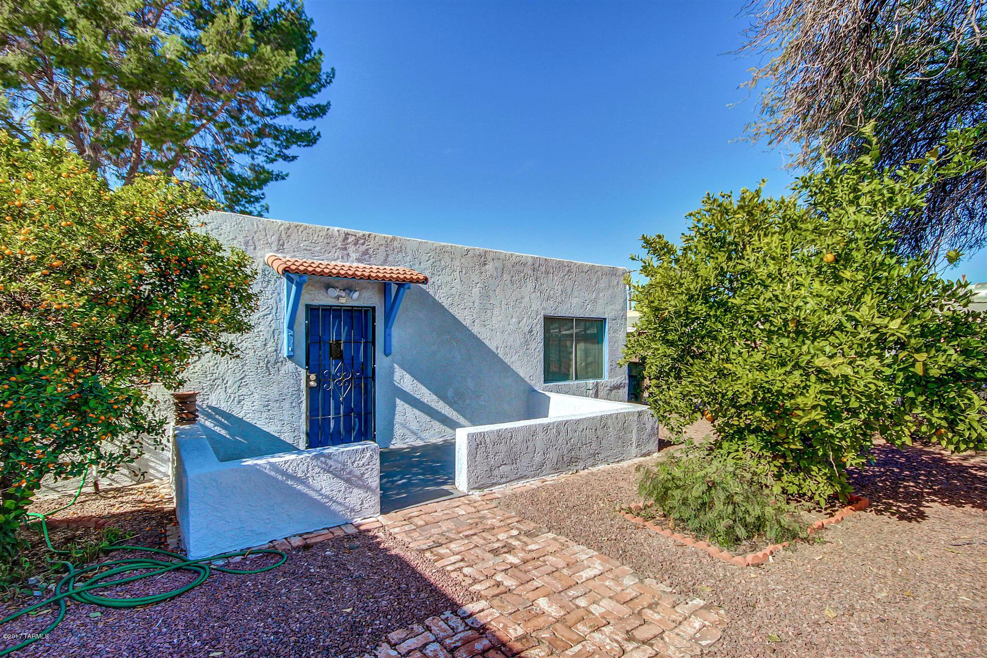Fantastic 2 bed, in central Tucson. This property has much to be desired in the centrally located ''Flower Dodge'' Alvernon neighborhood.  Gorgeous exterior with lush landscaping. Inside features plush carpeting and neutral interior palette.  Comfy sized rooms, also with plush carpeting. Full bath with convenient built-in storage.  Window air conditioners in both bedrooms. There are security bars on all exterior doors. Front yard shaded carport. Good sized fenced backyard with brick patio and large pine shading outdoor living space could be enjoyed by family, friends and pets. Fruiting trees include Loquat and Blood orange and Calamondin citrus trees. Lots of built-in door storage, with 4 sizable outdoor sheds. Close to bus line, Walmart, dining and retail shopping. This is move in r