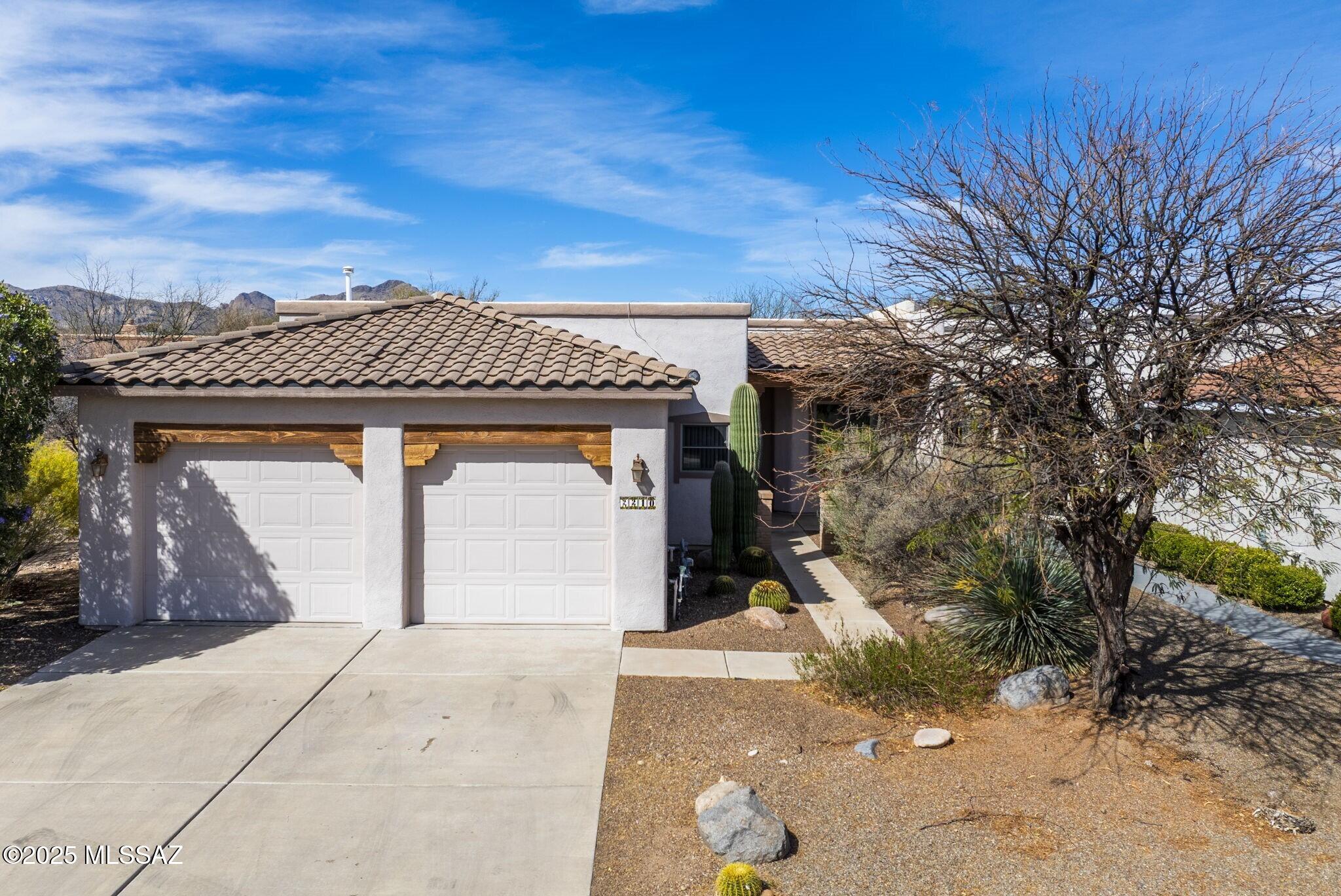 Nestled in the desirable Bosque subdivision of Tubac Barrio, this charming 2-bedroom townhome, complete with a den and bonus room, offers the perfect mix of classic Southwestern elegance and modern convenience. Enjoy privacy with no direct neighbors to the south and behind, complemented by serene common areas and a soothing waterfall. Inside, the open-concept living area welcomes you with a tile floor and a cozy kiva-style fireplace. The kitchen flows into the living and dining spaces, making it ideal for both everyday living and entertaining. The primary suite includes a large walk-in closet and an en suite bath featuring a double vanity, soaking tub, and separate step-in shower. Outside, a private courtyard offers a retreat with both covered and open areas perfect for entertaining.