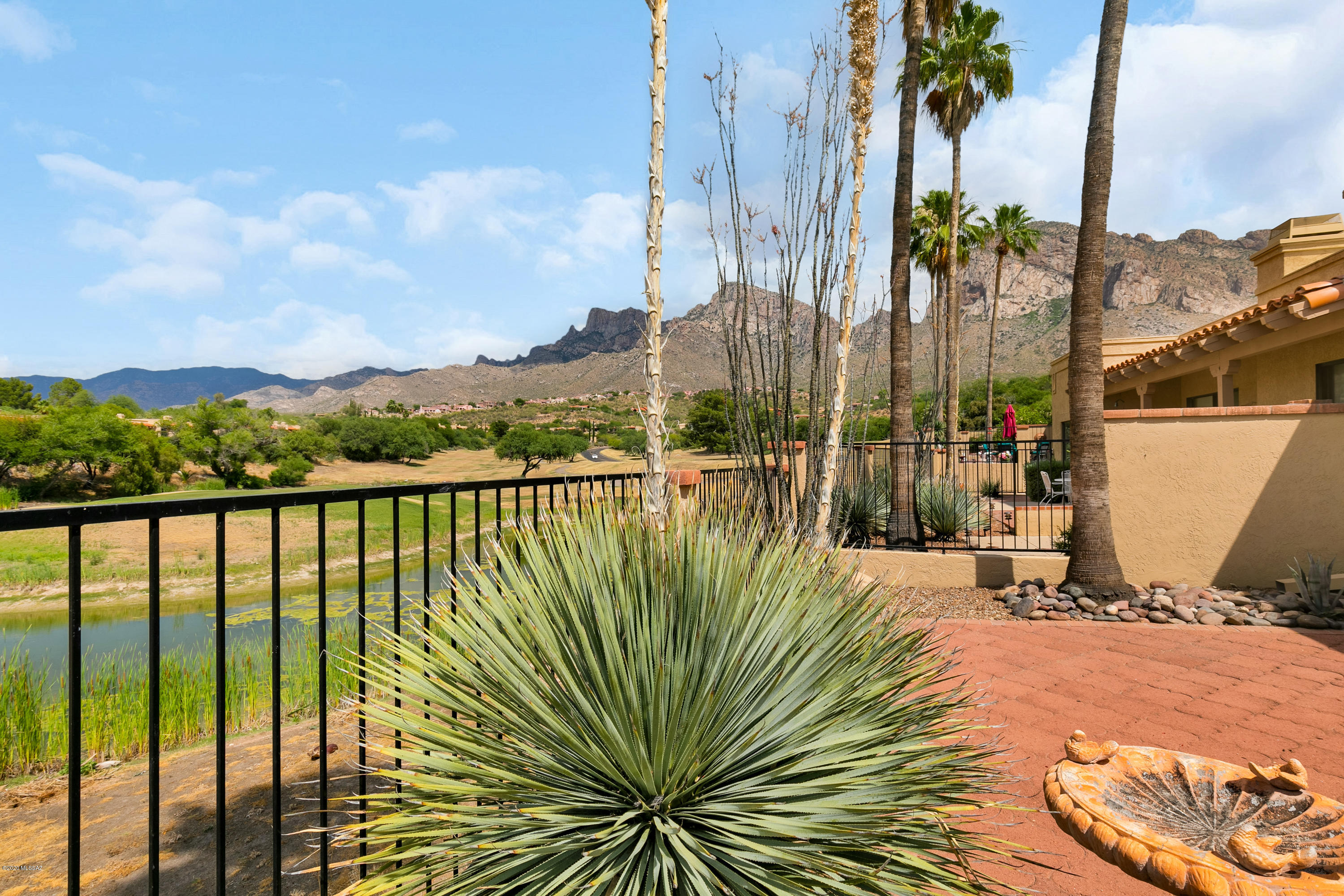 Desirable El Conquistador Patio Home on one of the most sought after lots.  This Former Model ,2 BR 2 BA  1445 Sq Ft overlooks the Pond, Golf Course and has STUNNING  Full Range views of Pusch Ridge .This Gently lived in home is being offered Turnkey. Move in and start enjoying the convenient location to shopping 
,golf, movie theaters  and hiking trails .  There is also the option of joining the El Conquistador membership and New Spa to be open within a few weeks.
The front courtyard has been relandscaped to welcome you with a beautiful fountain as the focal point which can be enjoyed from the inside as well. The home has been meticulously maintained The Phrase ''clean as a whistle'' fits here. The garage can be used for a hobby room as it can be cooled & heated. To much to list come se