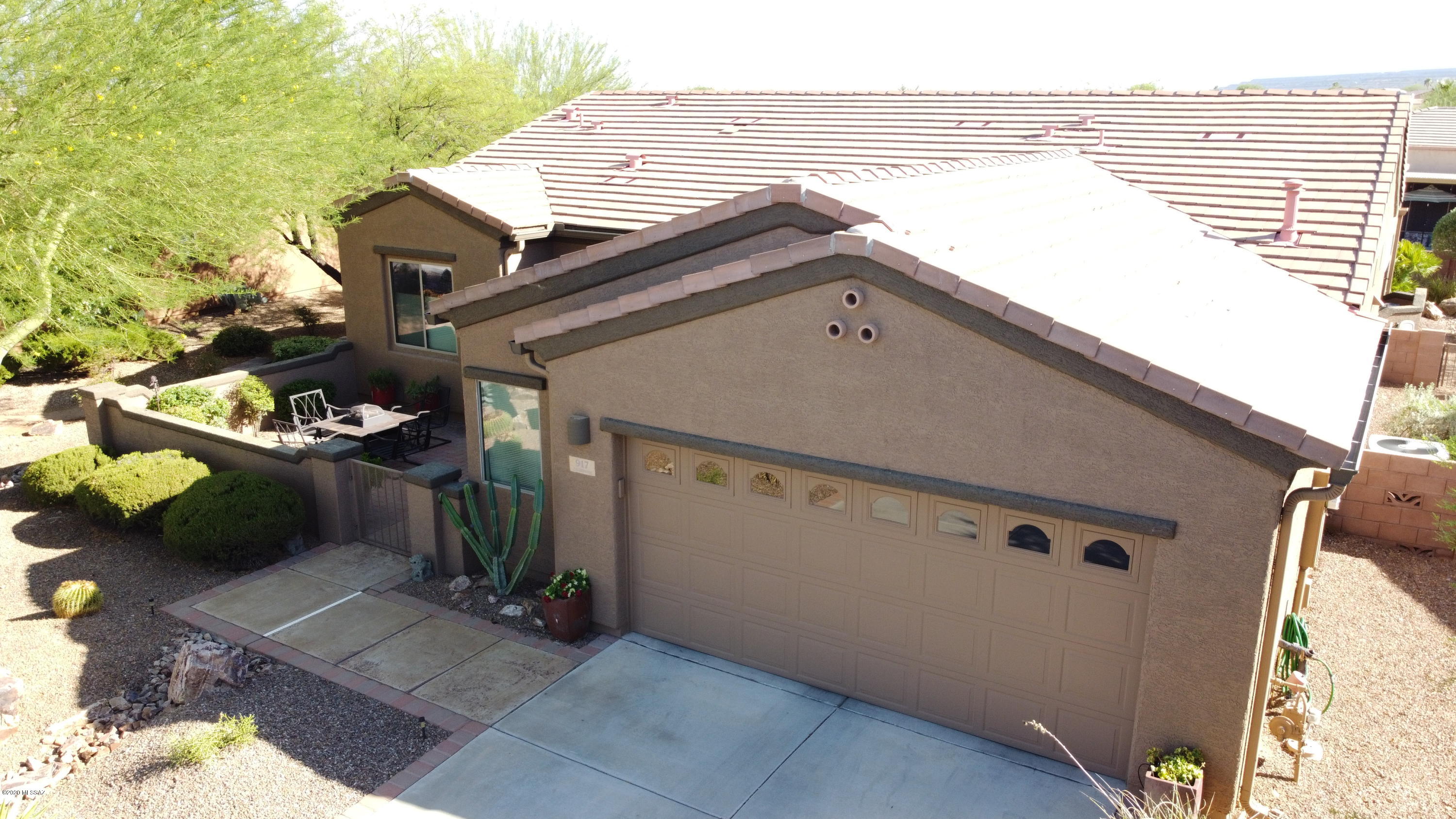 A Las Campanas Beauty, Great Room Home, A Welcoming Front Court Yard, 2 Bedrooms, 2 Baths, Den, Private Office and a Large 2 1/2 Car Garage with Storage Cabinets. If you need space this home has it. Tile Floors, Granite Counter Tops, Hickory Cabinets, Beehive Fireplace, Custom Paint, Ceiling Fans, Gutters and many more great features. Back Patio features an added Pergola with Roll Down Solar Screen, Nice Views of the Santa Rita Mountains. This yard would be great for entertaining.  There is a Portable Spa on Patio by Separate Bill of Sale. Must See this One!