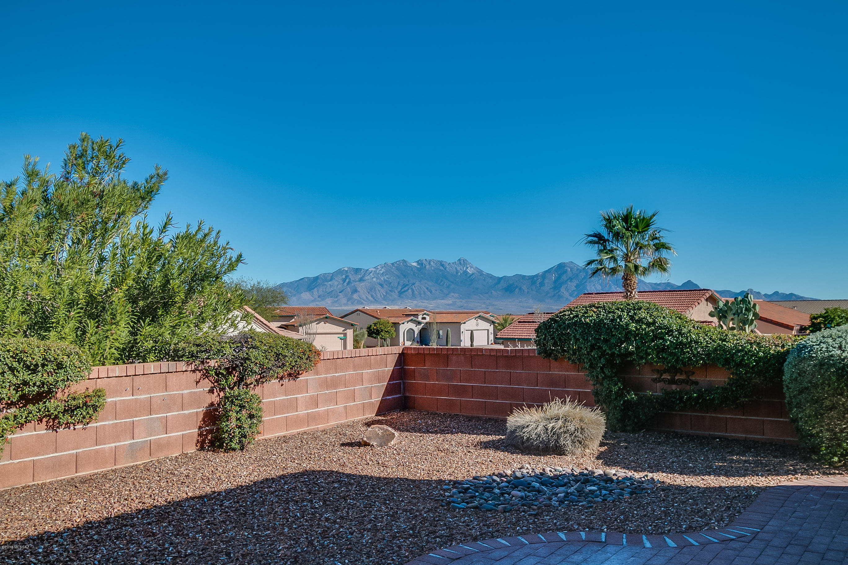 East-Facing Patio with great views of the Santa Rita Mountains! Nice curb appeal with crisp desert landscaping complete with a front courtyard. The San Miguel floor plan is just the right size with 1507 square feet; 2 BR; 2BA and large office/hobby area. Terrific size great room and plantation shutters throughout the home. The kitchen has an abundance of cabinets and a convenient breakfast bar too. A split bedroom arrangement with the master suite on the southeast side of the home. The screened Arizona room is sure to be a place where you will enjoy quiet time reading a book or conversing with friends! A very convenient location in the heart of Green Valley near the Las Campanas Recreation Center, Green Valley Library, churches, shopping and restaurants. A gem indeed!