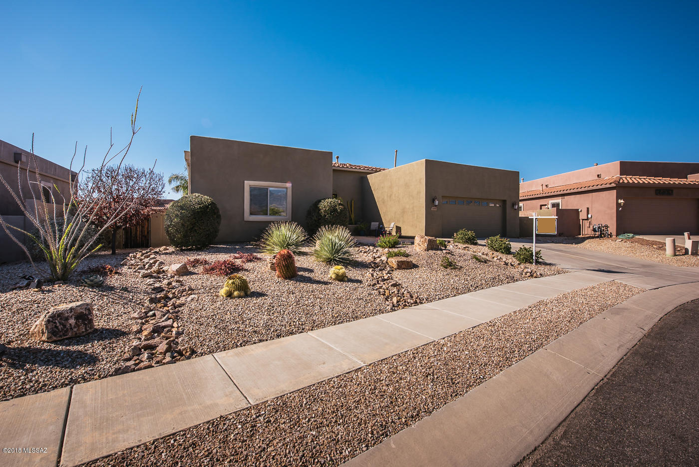 Get ready to fall in love with this contemporary style property with beautiful 360 degree panoramic mountain views. This home provides a “mini resort” feel with a spectacular saltwater pool & spa all within walking distance to popular Hohokam Park in Rancho Vistoso. Lounge under the large covered patio area with dual fans and a wonderful view of the Tortilla Mountains.  Here you will be able to hear the sounds of golfers teeing off on the 16th hole at the Vistoso Golf Club. The fenced backyard backs up to a lush desert common for more privacy and a multitude of wildlife viewing. Step inside the house and you’ll walk into the sought after open living spaces where it is complimented by the split bedroom floorplan that delivers privacy while guests are visiting. Watch the light dance through the backsplash height glass block windows onto your granite counters in this gourmet kitchen with modern cabinetry, dual ovens, gas range and a pantry. Enjoy your spacious master suite with abundant closet space and a fully appointed bath with soaking tub and walk in shower. Guest bath is flanked by two guest bedrooms and an oversized laundry room that provides extra storage. An added bonus is the high ceilings and oversized windows that accentuate the beauty of this immaculately maintained property. The excellent location is convenient for all with close to shopping, dining, movies and more. Stone Terrace is a lovely enclave of homes located in the master-planned community of Rancho Vistoso in Oro Valley, Arizona. In addition to the quiet beauty of the Vistoso Golf Course, Rancho Vistoso homeowners living in the Stone Terrace subdivision can also enjoy the convenience of having Hohokam Park, one of the most scenic and well-appointed in Rancho Vistoso within walking distance of home. With an enclosed dog park, a large children's play area, access to walking and biking trails, tennis, volleyball and basketball courts. Hohokam Park has something for everyone. Ramada's and barbeque grills, in addition to the expansive tree-shaded grassy areas, make this park ideal for residents of Rancho Vistoso to have a picnic close to home.