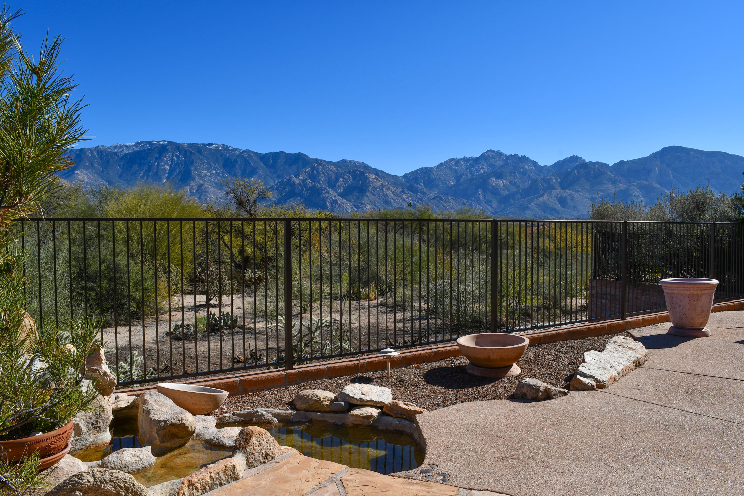 Spectacular Catalina Mountain Views from Inside & Out of this Sun City Oro Valley Home in an Extremely Private & Peaceful Setting Backing To Open Space. Full roof replacement and 1 new HVAC.  Kitchen with New Stainless Appliances, Center Island with Breakfast Bar, French Door Refrigerator & Breakfast Nook. Open Family Room w/ Inviting Double Sided Fireplace. Living Room with Mountain Views . Master Suite with Bay Windows & Walk-in Closet with Built-ins. Master Bath w/ Soaking Tub, Separate Shower & Double Sink Vanity. 2 Comfortable Guest Rooms & Full Bath. Computer/Hobby & Powder Rooms. Private Outdoor Living Space w/ Covered Porch, Flagstone Patio & Unobstructed Mountain Views. Extended Garage w/ Golf Cart Bay, Epoxy Floors & Storage Cabinets. Fresh Paint, New Carpet & Tile. Move-in Ready