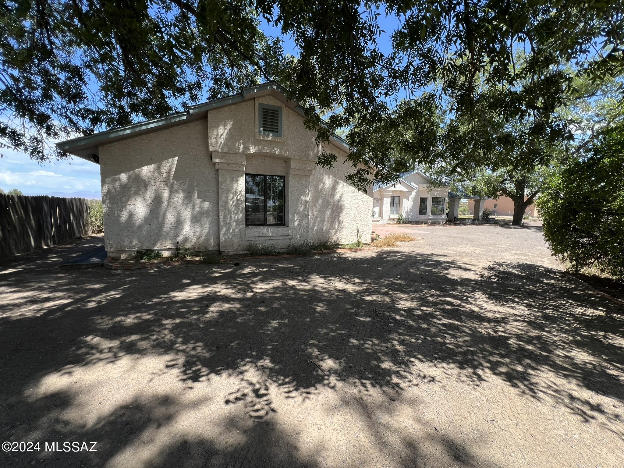 Immaculate one-of-a-kind residential duplex! Home #1: neutral tones, natural light, patio access; kitchen/dining w/warm floor-to-ceiling cabinets, appliances, walk-in pantry; bed/bad w/16-drawer built in dresser, oversized walk-in closet, soaker tub/shower, seated vanity; 2-car garage! Home #2: sleek/bright w/decorative shelving, fireplace, patio access; kitchen/dining w/white cabinets, walk-in pantry; bed/bath has patio access, skylights, soaker tub/shower, dual vanity, walk-in closet; attached covered carport w/storage & front entrance! Common foyer, laundry & 3rd bed/bath for guests! 987 ft² covered back patio, mature trees, lush laws with ditch irrigation!