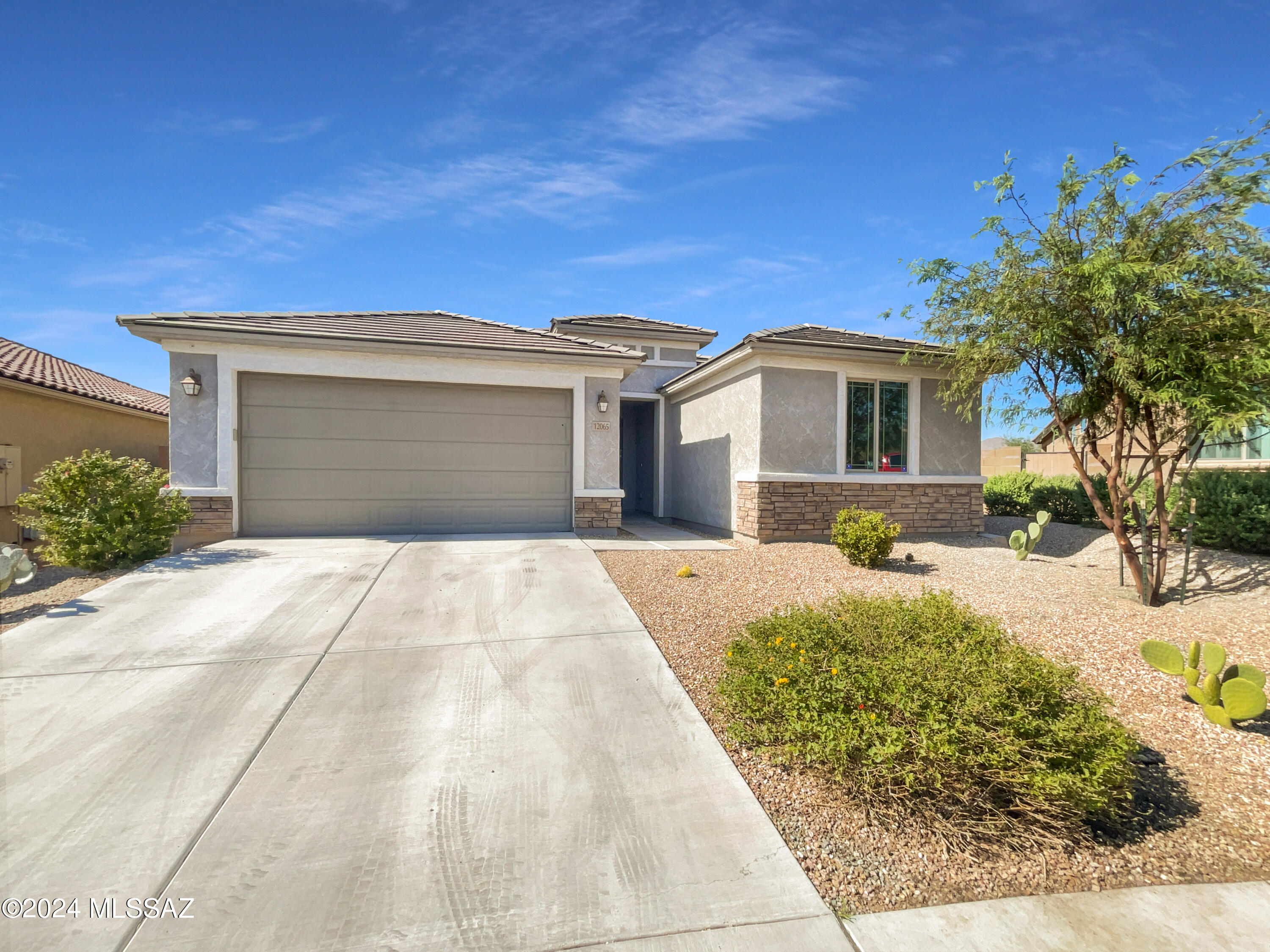 Welcome to a beautifully maintained property, boasting  fresh interior paint in a neutral color scheme that enhances its charm. Four bedrooms with an office. The gourmet kitchen is a chef's dream with an accent backsplash, an island for extra prep space, and all stainless steel appliances. The primary bathroom features double sinks for convenience, while the primary bedroom has a spacious walk-in closet. Step outside to a covered patio with fenced in backyard perfect for outdoor relaxation, and a large lot. The yard is also surrounded by low maintenance landscaping, allowing for more leisure time. Located in gated Tangerine Ridge in NW Tucson, so close to I-10, parks, bike paths and shopping. This home is a true gem waiting to be discovered.