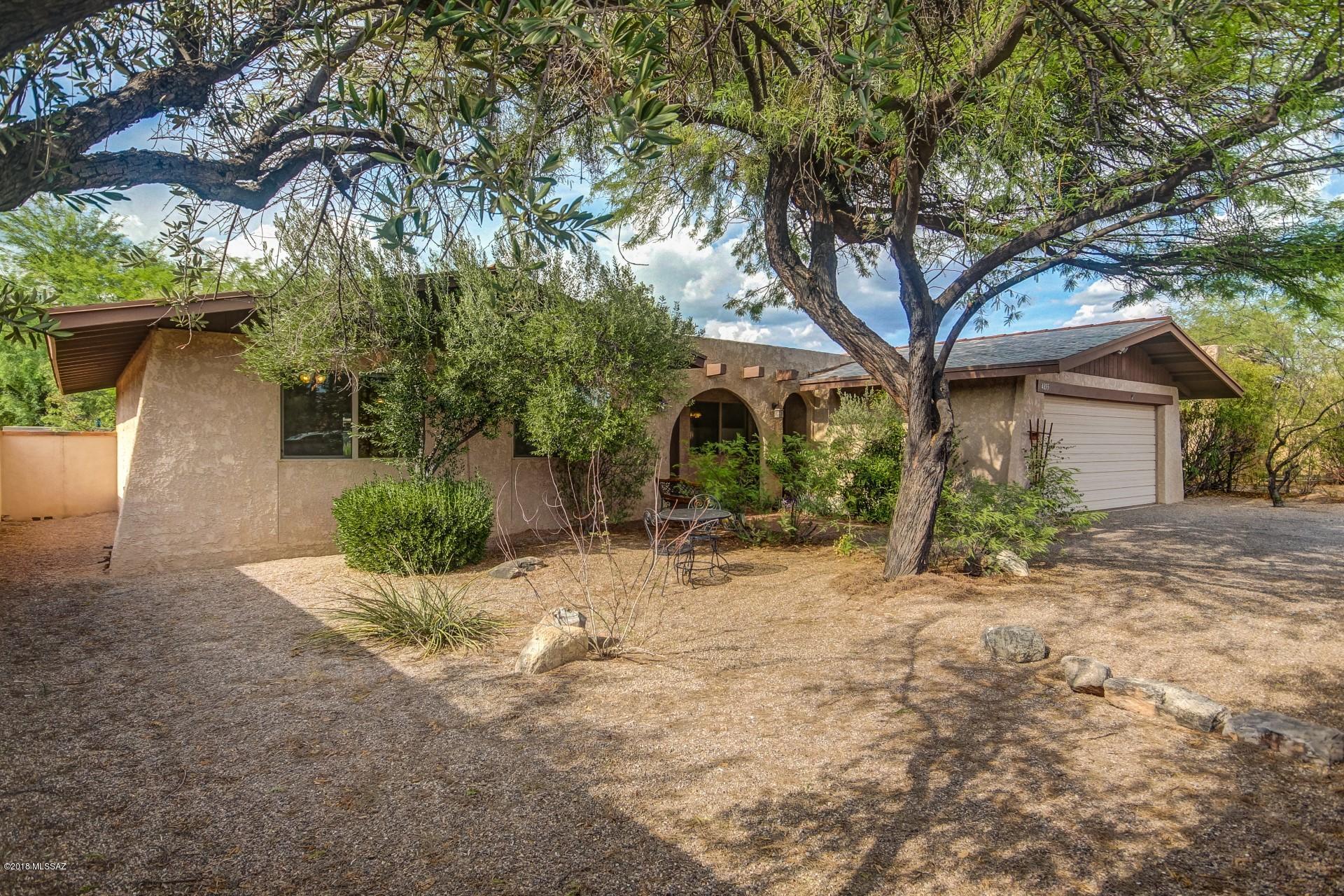 Newly renovated Tucson house offers the perfect home like feel! Cozy two-way fireplace, soothing custom paint tones, and gorgeous wood & tile flooring will make decorating an easy task! Gourmet kitchen will delight any chef with the stainless steel appliances, custom white appliances, granite counters, farmhouse style sink, and huge center island! Three spacious bedrooms! Master has a private exit, walk in closet, and an adjoining bath. Relax under the covered patio that overlooks the serene backyard with low care landscape, and mature shade trees. Don't miss this amazing and rare find!