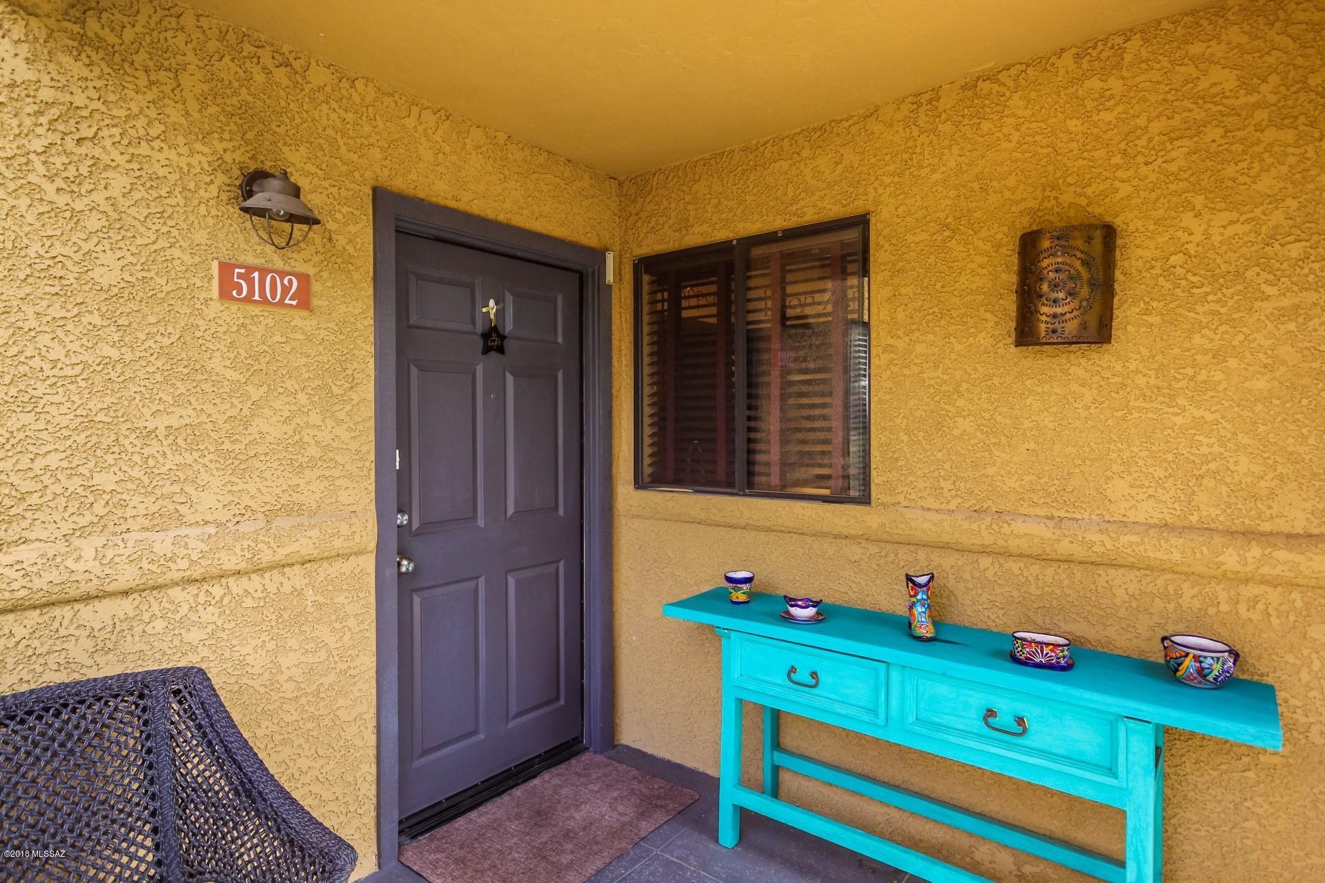Charming ground floor 3 bd/ 2 ba condo with covered patio entry and Model ''perfect'' interior.  Warm & welcoming palette, neutral tile floors, window blinds, ceiling fans, French door to patio, and cozy tiled fireplace for those occasional chilly nights.  Fantastic kitchen boasts granite counters, SS/black appliances, pantry, and plenty of wood cabinets with hardware.  Master retreat offers patio access and private upscale en suite with custom gorgeous glass shower enclosures in both bathrooms. Generous size bedrooms and ample closets. Enjoy the private covered patio! Community Pool. This wonderful Home will NOT last!!