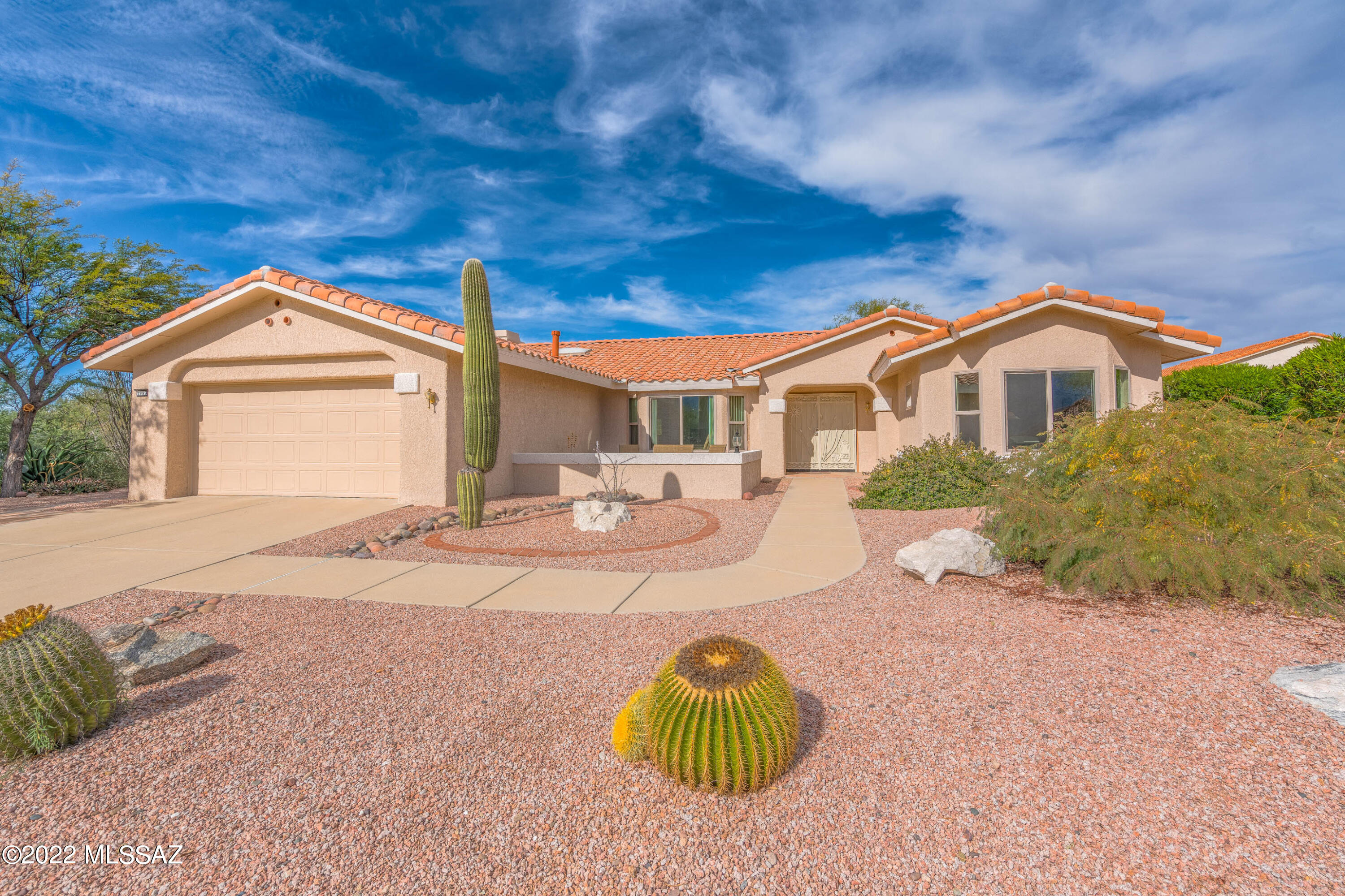 Spectacular 3BD/2BA (2,163 SF) home on large golf course lot in Sun City Oro Valley. Fabulous brick paver courtyard has striking Catalina views. Tranquil rear yard offers covered/uncovered patios, inground spa, beehive fireplace & lush landscape. Four bay windows accent Great room and bedrooms. Inviting entry flows to a formal Living/Dining room w/vaulted ceiling, skylight and adjacent bonus room. Beyond lies an expansive Great room w/fireplace and patio access. Kitchen boasts an island w/breakfast bar, gas cooktop, in-wall combo oven & stainless fridge. Owner's suite hosts a jetted tub plus walk-in shower and closet. Large front guest room w/Catalina views, rear guest room and full hall bath. Cabinets, water softener & utility sink in garage. Sun City is an active adult community.