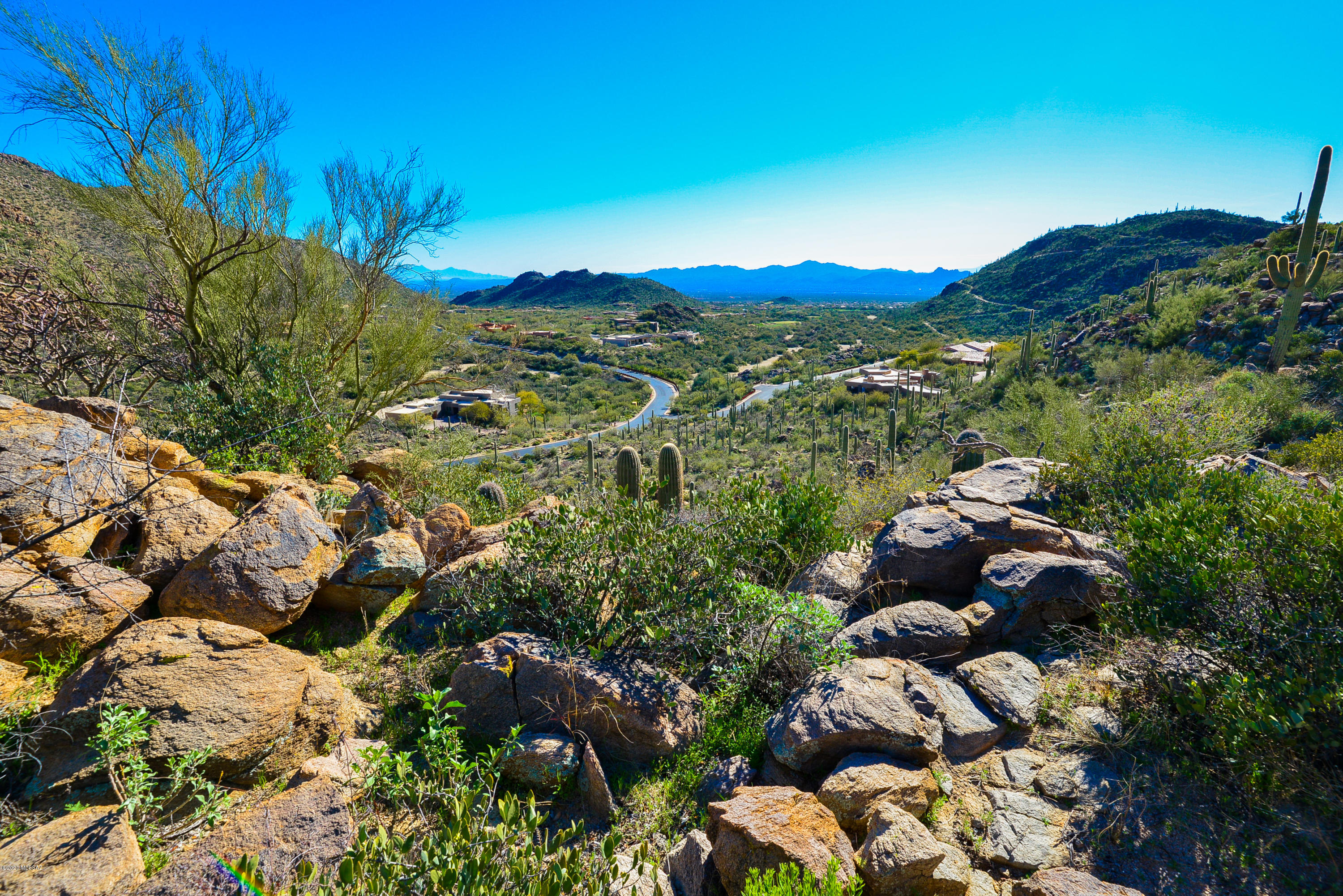 One of the true trophy home sites in the Prestigious Canyon Pass. Stunning mountain and city views abound from this very buildable 4+ acre parcel. Surrounded by major estates this AAA location offers a blank palette from which to build your Dream Home.