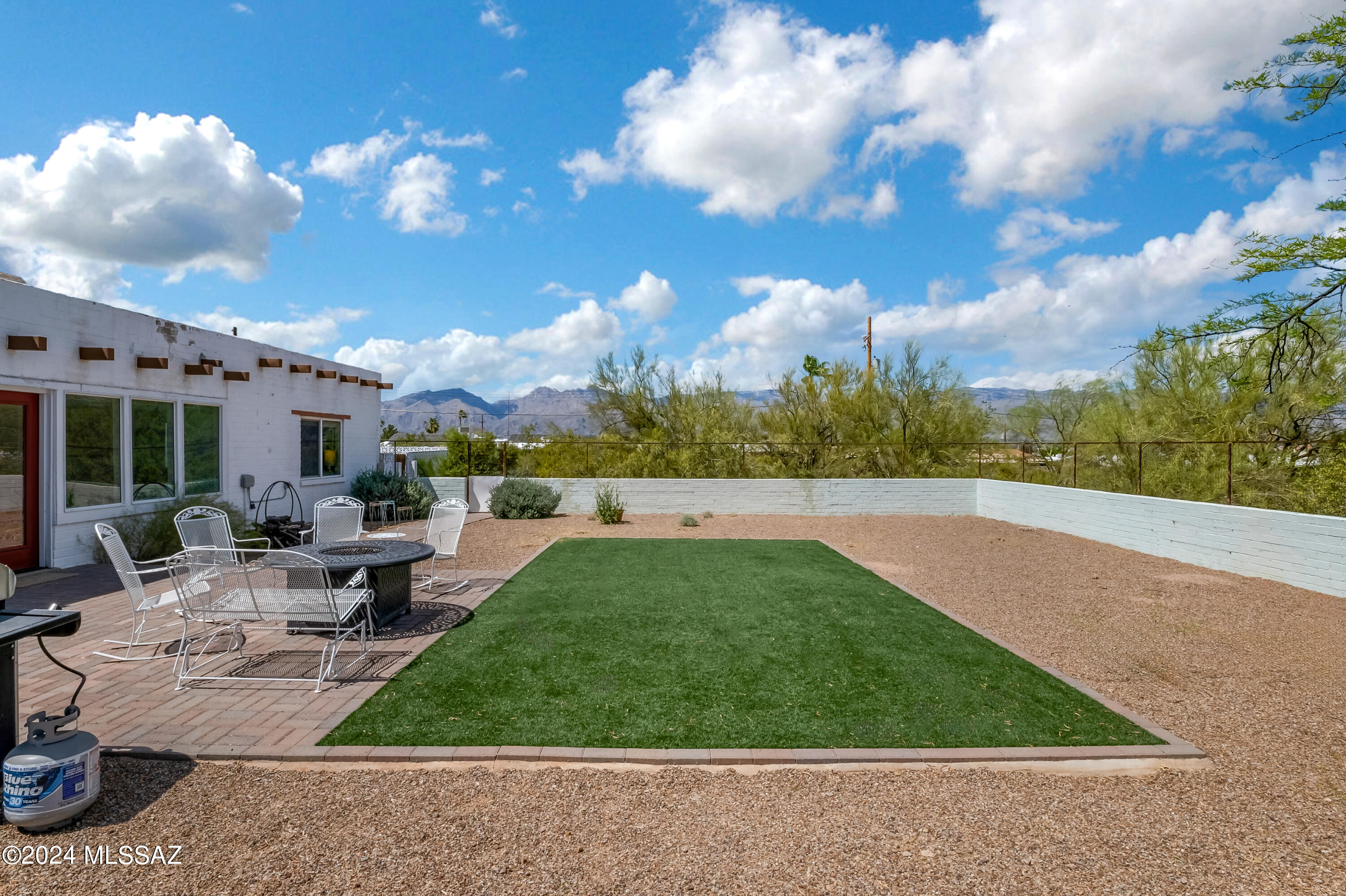 RARE OFFERING!!! Very unique opportunity to own an old historic Tucson ranch home. Located in town on over 1 1/3 acres, this 1940's home used to run a large eastside ranch. Home still has old charm combined with modern offerings. Exposed beam ceilings, concrete floors and block construction provide an 'old west' feeling while the air conditioning, swimming pool, stainless appliances and dual pane windows give you the amenities you've become used to. 

Small detached 'tack room' can be repurposed for whatever you desire- art studio, poker room, storage etc. 

Not often you can be right in the middle of town and experience this type of privacy and solitude. There is a separate yard from the pool to keep your kids or pets safe or just enjoy a morning sunrise over the Rincon mountains.